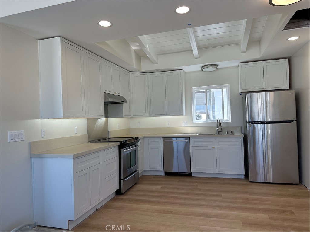 Looking for a location that suites your lifestyle? Leave the e-bike at home and walk or strand cruise it to your favorite places! Remodeled to the studs complete August of 2025, 213 Marine Avenue Unit C is a 3 bedroom 1 and 3/4 bathroom upper rear home in 1963-built triplex that will soon be completely remodeled. Must see to appreciate. This quiet unit off 21st Place is nine houses to the beach, a short walk to Grandview Elementary, just over the hill to Live Oak park, and an 8 minute walk to downtown along the Strand. The unit features a partial view of the ocean from the kitchen and living room as well as a peak at Catalina Island from the primary suite. The new owner has remodeled it without sparing expense. The unit is fully electric with attic insulation, top-end heat pump providing both whisper-quiet heat in the winter and AC in the summer. LG stacked washer and dryer in the common bathroom which also features new vanity, tub, and shower tile. Luxury vinyl plank flooring throughout. The primary bedroom suite features dual closets, new vanity/faucet as well as a generously sized shower stall. The electrical system is state of the art. The kitchen boasts extensive lighting options as well as a Bosch dishwasher, LG fridge, and Whirlpool electric range with external venting. The home comes with 2 garage spaces (one to be provided once approved by the city expected by September) along with an additional space in front of the garages on 21st Place. Two 60 amp 220 volt outlets are provided in the garages to quickly power electric vehicles.