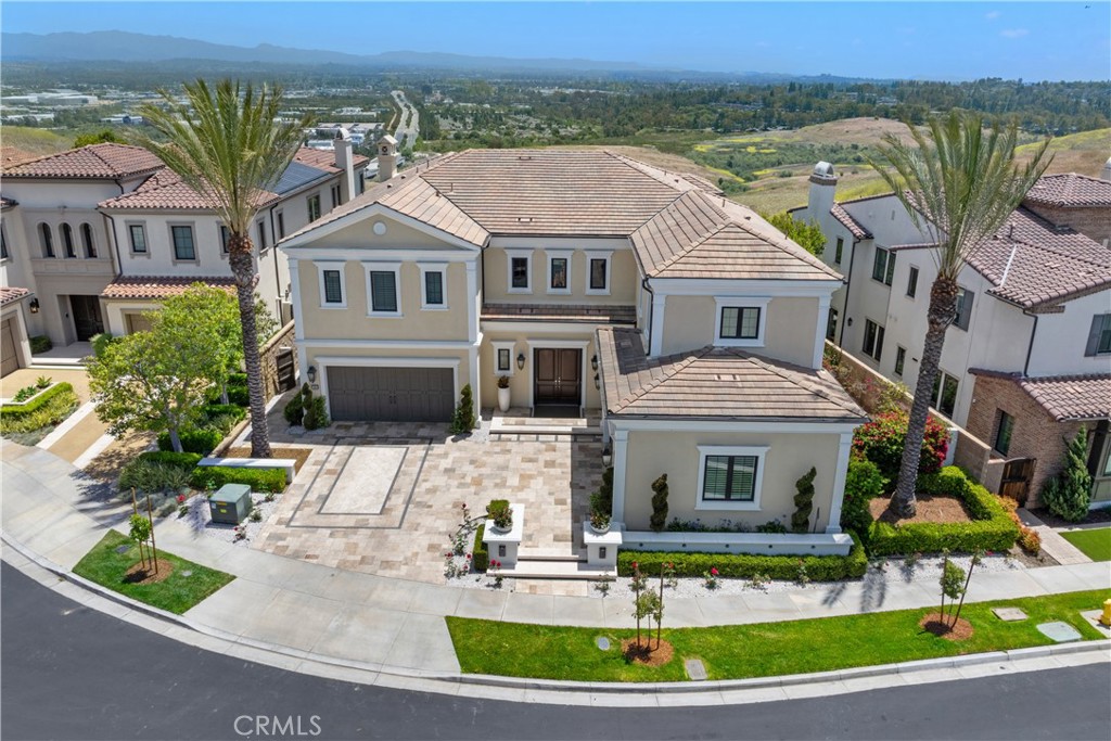 Presenting one of THE most magnificent Contemporary Estate Homes in Irvine with stunning unobstructed panoramic views of city lights, and the coastal hills of Laguna Beach Wilderness open space. The incredible "Crown Jewel" of the prestigious 24/7 guard-gated community of Hidden Canyon The immaculate "Marbella" estate is situated in the esteemed upper level of the community, and includes 5 ensuite Bedrooms, 6 Baths spanning nearly 5,923 SF of luxury living space, on an expansive 10,467 SF cul-de-sac PREMIUM LOT on the most popular community view street in the upper levels. This remarkable estate home is impressive from the moment one enters the two-story Grand Foyer with dramatic dual staircases and chic chandelier. The welcoming open floor plan with oversize windows and large pocket doors invite ample natural light and frame coastal hill and city lights views from nearly every room. The main level dazzles with contemporary flare including imported tile flooring, spectacular finishes, designer window treatments, and custom stone fireplaces. The chef-inspired primary kitchen with dual kitchen islands, is coupled with an inter-connecting secondary kitchen. The kitchens feature Sub-Zero refrigerators, 4 WOLF Ovens, two WOLF Stoves is coupled with a full second kitchen for full-scale entertaining. The main level features a MAINLEVEL BEDROOM LIVING SUITE, formal dining room, conservatory, and great room interconnected to an outdoor area beyond imagination. Upon stepping outside - the expansive space includes a Pool, Spa, covered seating logia, and views to beyond imagination. The upstairs unveils a gorgeous large Primary Suite, three spacious en-suite bedrooms, Loft, and a Laundry Room. The Primary Suite is especially impressive with oversize windows to enjoy views for miles. The elegant spa-like primary bath features a large walk-in "dual" shower, bathtub, and beautifully designed master closet. Additional highlights of this exceptional estate include upgraded security system, Solar Panels, 2 two-car garages, upgraded water heating and pressure system, remote control shades, and water softener. You will feel like you are worlds away, set high above the beauty of Orange County’s rolling coastal hills to enjoy breath-taking sunrises and sunsets. Hidden Canyon is recognized as the most exclusive contemporary home, 24/7 gated estate communities in Irvine and Orange County! Welcome home to your luxury eview state!