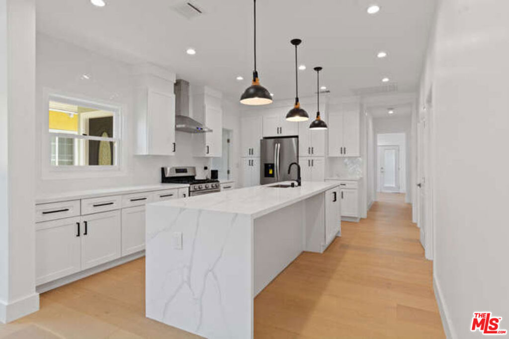 Welcome to this stunning, move-in ready and completely remodeled 4 bedroom, 2 bath Craftsman style home in the highly desired Jefferson Park Area! centrally located and just minutes from DTLA, Beach, USC, Museums, shopping and some of the best restaurants in the city. This turnkey home boasts an open floor plan concept for living room, dining area, and kitchen, great for entertaining! Engineered hardwood floors and recessed lighting throughout. The gorgeous remodeled kitchen features a large center island with quartz counter tops, pendant lighting, shaker cabinets, backsplash, and stainless-steel appliances. The spacious master bedroom has recessed lighting and a large walk-in closet. The master bathroom offers a new vanity with quartz countertops, new tile flooring, dual sinks, gorgeous new vanity, skylight, sunken bathtub and a separate enclosed seamless glass shower. Newly installed upgrades include: central heating and air conditioning; Brand new electrical, and plumbing, new interior doors, new roof, new light fixtures throughout. Large back yard with plenty of room for entertaining. Fruit trees include avocado and guava. Newly built carport and direct access from alley. Don't miss this incredible property!