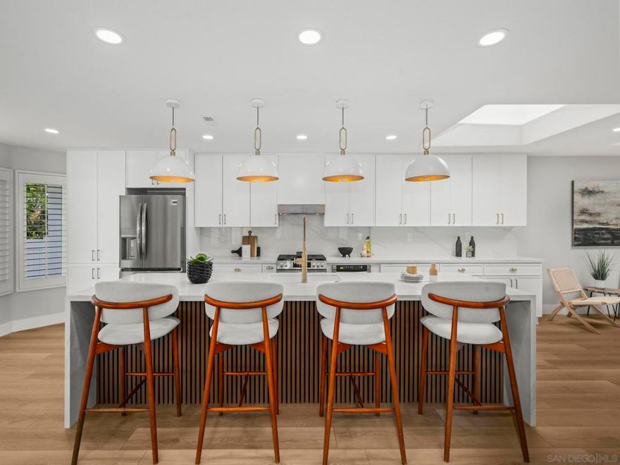 4994 Alicante Way – Oceanside Luxury, All on One Level Experience refined coastal living in this exquisitely remodeled single-story residence. At the heart of the home lies a show-stopping dream kitchen, anchored by an impressive 12-foot island—the ultimate centerpiece for gatherings and culinary creations. Custom cabinetry, premium countertops, and top-tier appliances set the stage for effortless elegance, while a stylish mini bar adds a touch of sophistication for evening cocktails or weekend entertaining. Designed for those who love to host, this home is truly an entertainer’s dream, with an open, sun-filled layout that flows seamlessly to private outdoor spaces perfect for dining and relaxation. Every detail reflects luxury, from the high-end finishes and designer lighting to the crisp, modern flooring throughout. Immaculate, contemporary, and move-in ready, this home defines upscale Oceanside living—and it will not stay on the market for long.