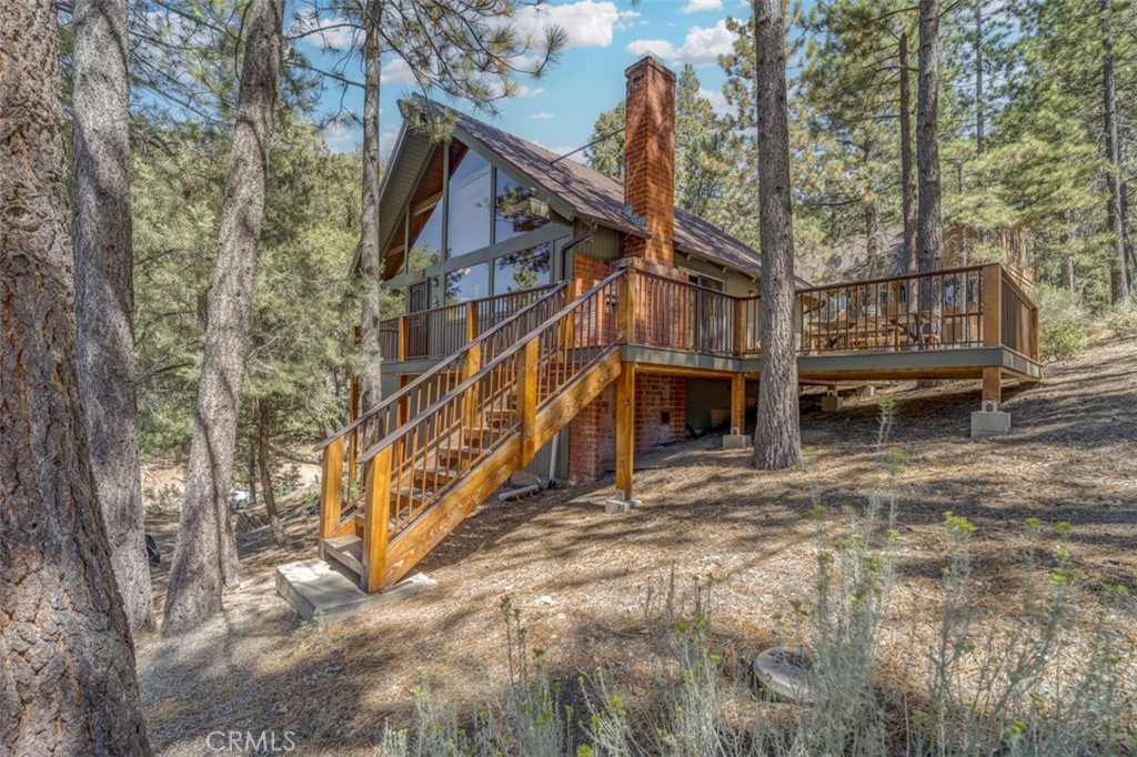 Your Mountain Sanctuary Awaits at 1515 Lassen Way, Pine Mountain Club, CA. Close your eyes and imagine waking to the soft whisper of pine trees, sunlight spilling through grand windows, and the crisp mountain air calling you to a sprawling deck with your morning coffee. Welcome to 1515 Lassen Way, a 1,129-square-foot, 2-bedroom, 1-bathroom cozy cabin nestled in the tranquil, private upper reaches of Pine Mountain Club, California. This isn’t just a home—it’s a haven, a place where the city’s hustle dissolves into the serene embrace of nature. As you approach, the cabin’s classic exterior, recently painted to enhance its timeless appeal and tucked among lush forest, radiates warmth and serenity. Step inside, and you’re greeted by soaring vaulted ceilings adorned with knotty pine paneling, exuding authentic mountain charm. The open living space feels both grand and intimate, with natural light pouring through oversized windows that frame breathtaking forest views—scenes so captivating they could inspire a poet. Imagine cozy evenings by the fire with a book or lively gatherings with friends who’ll envy your retreat. The two bedrooms offer peaceful sanctuaries, while the well-designed bathroom ensures comfort. The heart of this home is its spacious deck, crafted with durable, low-maintenance Trex decking, perfect for summer barbecues, stargazing under a pristine mountain sky, or simply soaking in the forest’s beauty. Whether you seek a weekend escape or a forever home, this cabin embodies the mountain lifestyle. Pine Mountain Club elevates living with exclusive amenities: a sparkling pool, welcoming clubhouse, scenic golf course, tennis courts, and 24/7 patrol for peace of mind. Hike nearby trails, breathe pine-scented air, or perfect your swing—all just steps away. 1515 Lassen Way is your chance to live where every day feels like a retreat. Schedule a showing and let the mountains steal your heart!