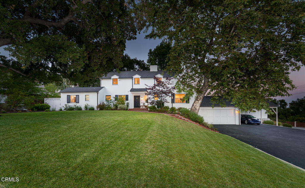 Built in 1941 this expansive estate-sized residence is positioned on an oversized lot with private grounds. The 3,328 square foot home enjoys four bedrooms, three and a half bathrooms and offers a rare blend of refined elegance and outdoor splendor. Designed for those who value both privacy and presence, the property features a sprawling yard perfectly manicured and thoughtfully designed for grand entertaining or quiet retreat.Anchoring the outdoor space is a resort inspired pool and jacuzzi, framed by lush and mature landscaping. The pool deck is surrounded by multiple lounging and dining areas. Whether you're hosting sunset soirees, weekend brunches, or simply relaxing in your own private paradise, the ambiance is nothing short of extraordinary.Step inside to a warm and inviting formal living room with hardwood floors and oversized windows. The living area is centered around a decorative fireplace, perfect for cozy evenings or lively gatherings. The formal dining room is just beyond the living room and offers ample lighting through thoughtfully placed windows. The updated gourmet kitchen offers a delightful eat-in nook, contemporary finishes and is designed with entertaining in mind. Expansive windows and seamless indoor-outdoor flow ensure the magnificent grounds are always in view.Whether you're hosting a summer barbecue, unwinding under the stars, or simply enjoying your beautiful surroundings, this home enjoys the perfect setting for every lifestyle. Additional features include a full basement offering generous storage or a bonus space, and a welcoming front yard that enhances the home's curb appeal.