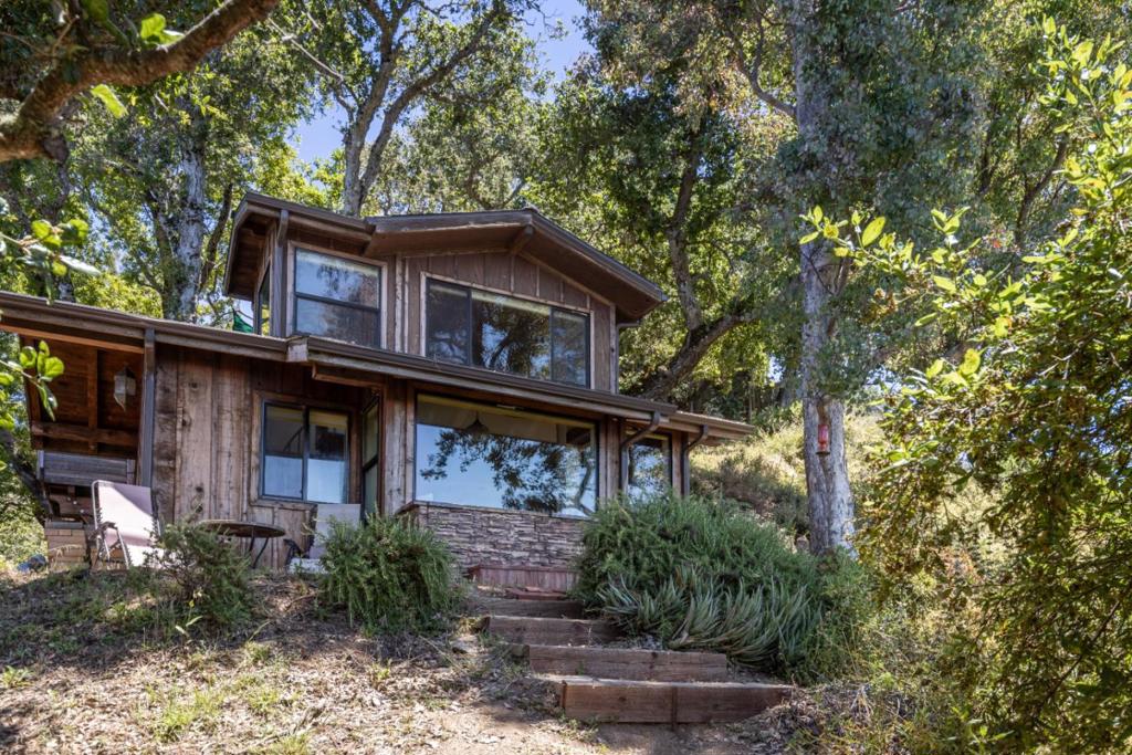Enjoy a peaceful escape at this off-grid ocean view property in the Lower Greenridge neighborhood of Palo Colorado. This is a tenants-in-common sale of one of two homes located on the parcel. The original 818 sq ft residence, affectionately known as The Treehouse, was crafted by a revered local builder and offers 2 bedrooms, 1 bathroom, radiant floors, concrete countertops, a large gas range, and sweeping ocean views from the upper-level bedroom. Thoughtfully designed for self-sufficient living, the property supports an off-grid lifestyle, blending charm, comfort, and natural beauty in a truly special setting. See ML82005551 to view the second listing included in the TIC. Do not disturb the occupants of the property - APPOINTMENT REQUIRED.