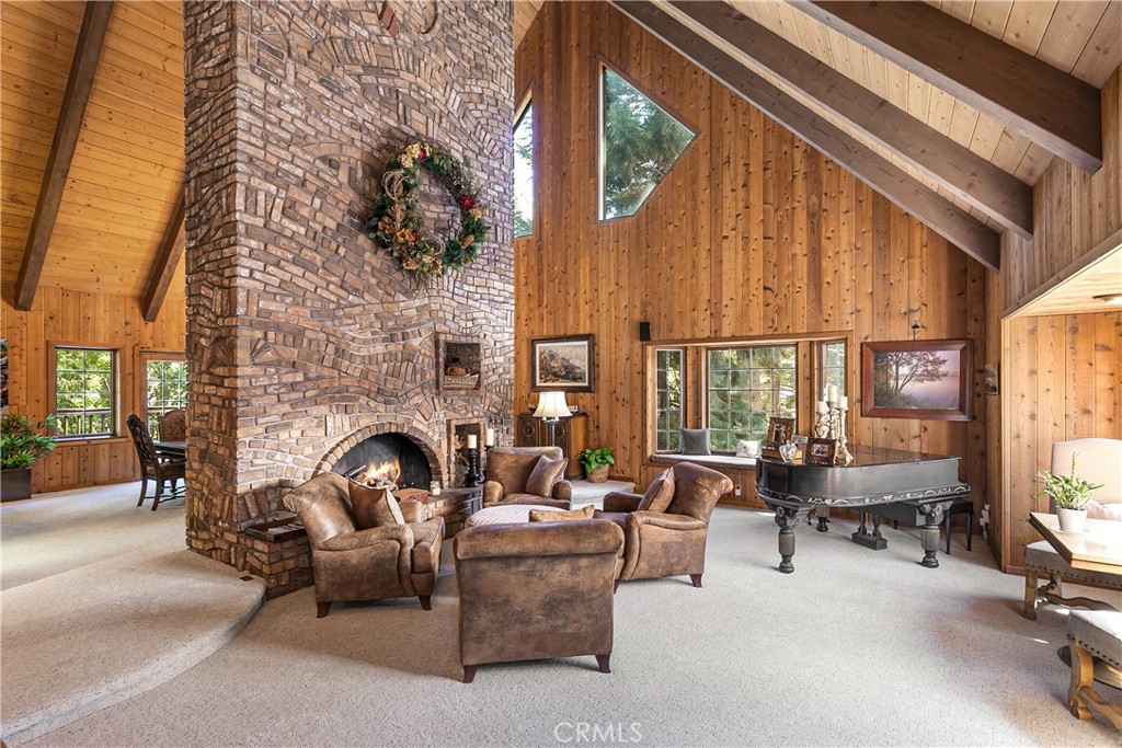 Epic Mountain Lodge-Style Home
Discover this beautiful and spacious 4-bedroom, 4.5-bath mountain retreat, complete with a bonus room which serves as a gym and includes a sauna under the garage, air conditioning, and a prime location very close to the lake.
Step inside and be welcomed by a soaring two-story brick fireplace, the dramatic centerpiece of the open living area. Expansive windows surround the space, flooding the home with natural light and showcasing the beauty of the surrounding trees.
The gourmet kitchen is a chef’s dream, featuring a Sub-Zero refrigerator, triple stainless steel sinks, and both a formal dining area and cozy breakfast nook. Step out onto the spacious deck to relax and take in the sights and sounds of the seasonal creek and serene streams flowing below.
Upstairs, you’ll find a spacious wet bar loft, perfectly designed as a game room and gathering space, a massive fireplace, along with a comfortable guest bedroom.
The luxurious primary suite is located on its own level, complete with a private fireplace, a spa-like bathroom featuring double-head showers, and a jetted soaking tub. Two additional bedrooms—one on the main level and one below—provide ample space for family and guests.
The family room below also features a beautiful fireplace for gatherings.
Enjoy level entry to both the two-car garage and front door for easy year-round access. The built-up area beneath the home doubles as a workshop, easily accessible. A Generac generator is included with the house.
Crafted with quality and attention to detail, this lodge-style home features wood siding, beam ceilings, and timeless mountain charm.
This is truly a must-see home to fully appreciate its warmth, beauty, and exceptional design.