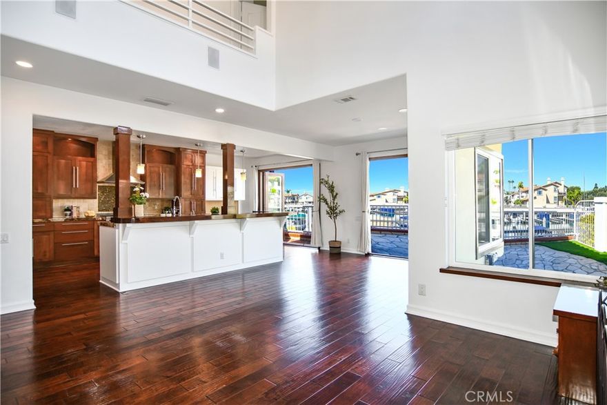 This is a stunner in Spinnaker Bay, complete with a DEEDED 36' boat slip strategically located steps in front of a generous wrap around deck that includes 46' of water frontage, and spectacular water views from this rare end unit. This sophisticated residence greets guests with soaring ceilings and a grand staircase. This is a truly exceptional home with an open floor concept and thoughtful well designed details from floor to ceiling windows with custom shades to rich updated cabinets (and plenty of them), flooring, Granite counter tops , and new high end stainless steel appliances. Upstairs you will find the primary suite with an ensuite bathroom, fireplace, Cedar lined walk-in closet and a custom dressing area, truly a retreat! And if entertaining is your thing, the accordion doors opening to the generous patio makes it the ideal indoor outdoor water front lifestyle.