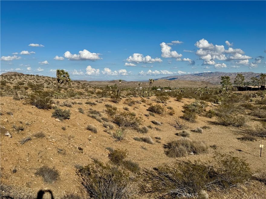 Escape to tranquility with this pristine 5-acre lot in the heart of Yucca Valley! Nestled just minutes from town, this property offers the perfect balance of convenience and privacy. Surrounded by mature desert vegetation and offering breathtaking views of the mountains, including Joshua Tree National Park, it’s a rare gem waiting to be developed. The lot is situated in a community known for its mix of contemporary desert architecture and well-maintained western ranch homes, providing a harmonious blend of modern living and rustic charm. With easy access to nearby Joshua Tree National Park, this property is an ideal spot for hiking, stargazing, or simply enjoying the beauty of the desert. Whether you’re looking for a peaceful retreat, planning to build your dream home, or seeking a smart investment, this lot offers endless possibilities. Don’t miss your chance to own a slice of desert paradise!
