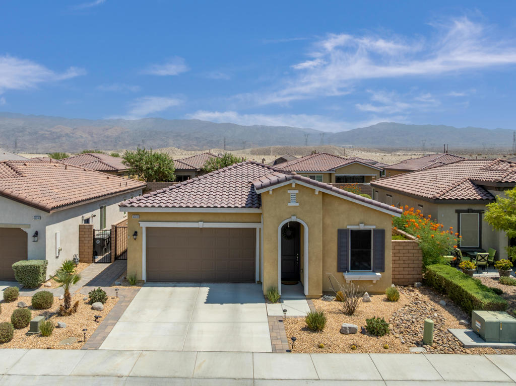 Four Seasons at Terra Lago is an active adult 55+ community located on prime real estate in Indio, CA. This newer 676-home community offers an unbeatable combination of comfort, convenience, and stunning surroundings. Whether you're an avid golfer or simply seeking a peaceful retreat, this home delivers everything you need for an incredible lifestyle. 43606 Treviso Drive is a spacious 2 bedroom / 2 bathroom (1,704 sq. ft) home with a large office / den area, that can be converted to a third bedroom. Perfect for entertaining guests and relaxation time, it features a bright and open living room & kitchen area. Large 2-car garage with plenty of storage space and room for a golf cart. Original owners have meticulously maintained this home and added numerous upgrades at time of purchase. Step outside to a well manicured backyard that has wonderful mountain views, plus a large retaining wall for privacy from neighbors. Surrounded with miles of walking trails, championship golf course and playgrounds for visiting family members and guests. This property offers a fantastic opportunity for both personal enjoyment and investment potential. Four Seasons at Terra Lago friendly environment offers numerous clubs and activities to get involved with. Low HOA fees ($300) include: top tier fitness center, clubhouse with pool/spa, bocce ball, tennis/pickleball courts, ping pong/billiards room, basketball, library/computer room & barbeque area. Located just minutes from local dining, golf courses, shopping and entertainment. Start the resort-style living you have always dreamed about and schedule your private tour today. Come home to your desert oasis.