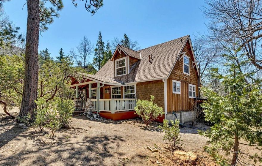Public Remarks:1957 Craftsman Bungalow is sited beautifully on a level lot among pines, cedars, manzanita, lilacs + gorgeous large oaks. A deep gabled porch, dormer window, stone piers + cedar shingles will have you charmed! The flat useable lot, views of Lily Rock, sunshine + mountain breezes offer plenty of places to relax + savor the mountain lifestyle. Meticulously maintained, this 1,025 SF, 2Bdm/1.5Bth cabin is fully furnished + move in ready. Pine paneled reading nooks w/views + an open living room w/the original rock fireplace provides ample space to enjoy your friends + family. The charming kitchen finds pine cabinets, classic tile counters, restored O'Keefe and Merritt range, natural Marmoleum flooring, plus built-in dining nook. A light and bright bedroom has plenty of storage and tree top views. The main floor bath brings vintage charm, w/bright period tile. The loft has space for two twin beds, a half bath + the second bedroom, all w/wood paneling + more views. The eye for detail is found throughout, creating the ultimate in mission style bungalow living. Ideally located in a quiet neighborhood, yet close to all Idyllwild has to offer. Note: items with a red dot will not be included.