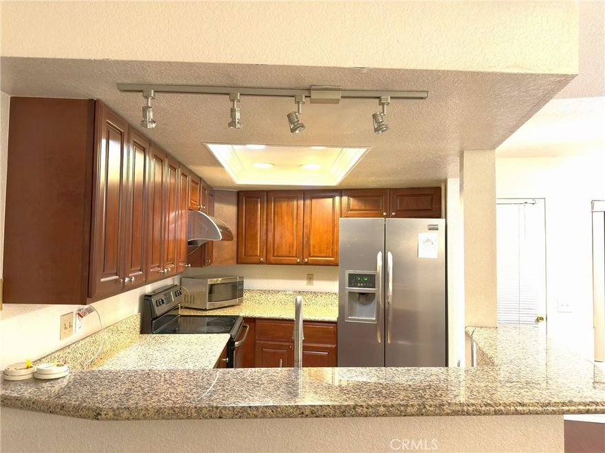 Upgraded Kitchen with newer cabinet and granite countertops. End Unit with no one above you. Great location bordering Diamond Bar and close to shopping, transportation, and schools. Good freeway access for commuting. Well maintained complex with lots of greenbelt in a Gated community. Unit is airy with an open floor plan. Lots of windows and lights, and good view too. Laminated wood flooring throughout and tiles in the kitchen