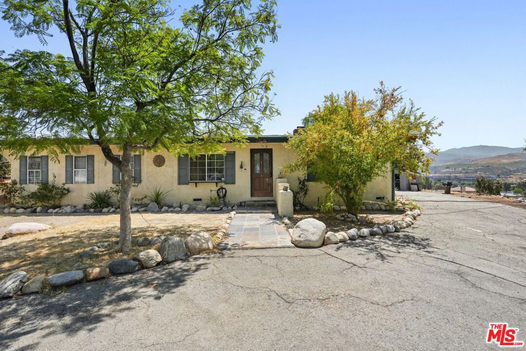 Welcome to 27420 Homyr Place, a rare property offering incredible potential on an expansive lot just under 1 acre, perched above Soledad Canyon Rd. This elevated home captures sweeping views of the valley, city lights, and mountains while placing you steps from shopping, dining, and commuter access. The existing 3-bedroom residence is a blank canvas for renovation, expansion, or redevelopment. With its generous lot size and potential commercial zoning uses, the property presents endless opportunities, whether you envision a custom estate, income-producing units, or a strategic investment hold. Enjoy the privacy of a hillside retreat with the convenience of being moments from schools, freeways, and Santa Clarita's best amenities. Lots of this size and location are rare. Don't miss the chance to capitalize on this oversized lot with unlimited potential in one of Southern California's fastest-growing communities!