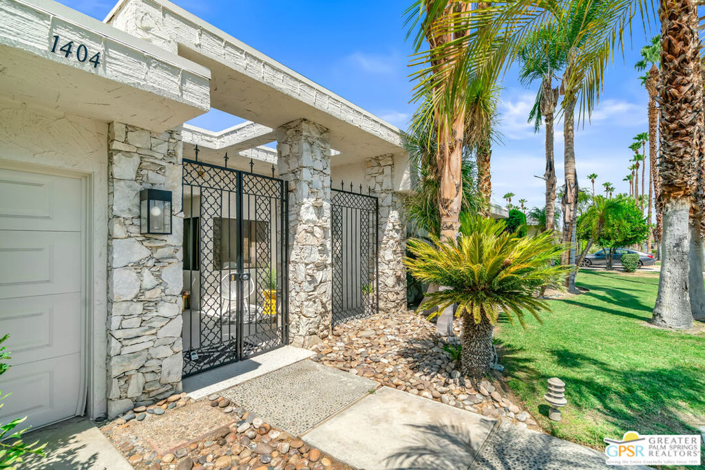 Experience Palm Springs' architectural heritage in this beautifully renovated Charles Du Bois-designed home, located in the coveted Canyon Estates community. Built in 1972 and fully updated between 2021 and today with approximately $300,000 in improvements, this residence perfectly blends preserved mid-century character with modern comfort, style, and efficiency, framed by panoramic mountain views and resort-style amenities. Step inside to terrazzo porcelain tile flooring that flows seamlessly from the entry through to the rear patio for effortless indoor/outdoor living. The focal point of the main living space features a stunning floor-to-ceiling gas fireplace in buff stone, built by the original stonemason who created the outdoor walls. The living room and hallway ceilings have been refinished, all interiors have been freshly painted, and over 40 recessed lights, plus six ceiling fans, have been installed for a bright and breezy feel. Three bathrooms have been completely reimagined with designer tile, custom vanities, premium fixtures, and cabinetry, while one original 1972 bath featuring its tub, walk-in closet, and vintage details remains preserved. Authentic mid-century elements include a mirrored entry ceiling, an original mirrored bar that adds a swanky 70's touch, and a mirrored accent wall in the former primary bedroom currently used as an office and guest bedroom, Lucite vanity pulls, sliding pocket doors, retro kitchen accordion doors, and original breakfast area cabinetry. The kitchen harmonizes classic design with modern updates, including a Bertazzoni gas range, Bosch dishwasher, reverse-osmosis filtration, and a dining room pass-through. In 2022, the original marquis-shaped pool was completely rebuilt with PebbleTec finish, glass tile, and an adjacent spa, both with remote control operation. Deck surfaces were refinished with cool-touch paint, and a full outdoor kitchen was added, complete with plumbed barbecue, sink, storage, and bar seating. Additional upgrades include a tiled outdoor shower, built-in concrete block planters and bench seating, and a gas firepit for evening gatherings. This home boasts a new 25-year roof, 37 owned solar panels (with an average electric bill of approximately $150/month), and a 14kW battery backup capable of powering essential appliances during outages. A new Trane AC system cools the main home, while a mini-split in the garage ensures year-round comfort for hobbies or storage. One other interior AC unit is also in place. Canyon Estates offers 15 sparkling pools, tennis and pickleball courts, a private, executive 9-hole golf course, landscape maintenance both in front and back yards, a fitness center, Spectrum cable and internet, a well-appointed clubhouse with many social activities, earthquake insurance, and lushly landscaped greenbelts. Select furnishings, including a rebuilt 13.5' vintage sofa with curved table, Barcelona chairs, pool lounges, and Adirondack seating, are available outside of escrow. This is a rare opportunity to own a masterfully restored mid-century modern gem offering architectural pedigree, thoughtful upgrades, and the ultimate Palm Springs resort lifestyle.