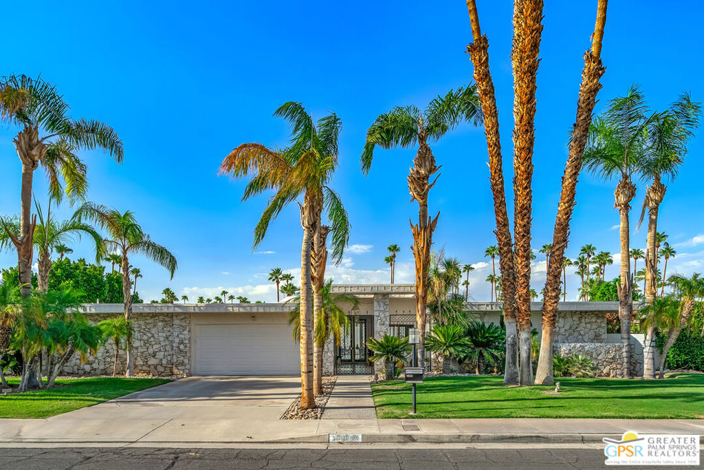 Experience Palm Springs' architectural heritage in this beautifully renovated Charles Du Bois-designed home, located within the Canyon Estates community in the desirable Indian Canyons neighborhood. Built in 1972 and fully updated between 2021 and today with approximately $300,000 in improvements, this residence perfectly blends preserved mid-century character with modern comfort, style, and efficiency, framed by panoramic, unobstructed mountain views without unsightly power poles and wires. Step inside to terrazzo porcelain tile flooring that flows seamlessly from the entry through to the rear patio for effortless indoor/outdoor living. The focal point of the main living space features a stunning floor-to-ceiling gas fireplace in buff stone, built by the original stonemason who created the outdoor walls. The living room and hallway ceilings have been refinished, all interiors have been freshly painted, and over 40 recessed lights, plus six ceiling fans, have been installed for a bright and breezy feel. Three bathrooms have been completely reimagined with designer tile, custom vanities, premium fixtures, and cabinetry, while one original 1972 bath featuring its tub, walk-in closet, and vintage details remains preserved. Authentic mid-century elements include a mirrored entry ceiling, an original mirrored bar that adds a swanky 70's touch, and a mirrored accent wall in the former primary bedroom currently used as an office and guest bedroom, Lucite vanity pulls, sliding pocket doors, retro kitchen accordion doors, and original breakfast area cabinetry. The kitchen harmonizes classic design with modern updates, including a Bertazzoni gas range, Bosch dishwasher, reverse-osmosis filtration, and a dining room pass-through. In 2022, the original marquis-shaped pool was completely rebuilt with PebbleTec finish, glass tile, and an adjacent spa, both with remote control operation. Deck surfaces were refinished with cool-touch paint, and a full outdoor kitchen was added, complete with plumbed barbecue, sink, storage, and bar seating. Additional upgrades include a tiled outdoor shower, built-in concrete block planters and bench seating, and a gas firepit for evening gatherings. This home boasts a new 25-year roof, 37 owned solar panels (with an average electric bill of approximately $150/month), and a 14kW battery backup capable of powering essential appliances during outages. A new Trane AC system cools the main home, while a mini-split in the garage ensures year-round comfort for hobbies or storage. One other interior AC unit is also in place. Canyon Estates offers 15 sparkling pools, tennis and pickleball courts, a private, executive 9-hole golf course, landscape maintenance both in front and back yards, a fitness center, Spectrum cable and internet, a well-appointed clubhouse with many social activities, earthquake insurance, and lushly landscaped greenbelts. Select furnishings, including a rebuilt 13.5' vintage sofa with curved table, Barcelona chairs, pool lounges, and Adirondack seating, are available outside of escrow. This is a rare opportunity to own a masterfully restored mid-century modern gem offering architectural pedigree, thoughtful upgrades, and the ultimate Palm Springs resort lifestyle.