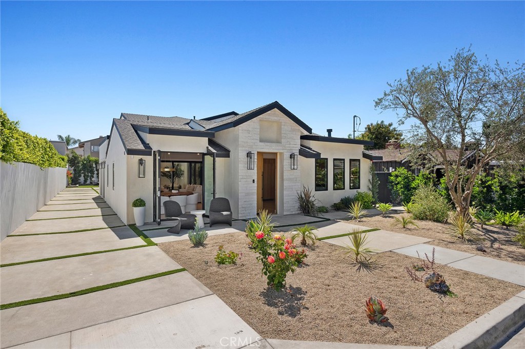 Newly Reimagined Modern Farmhouse | 4 Beds + Loft | 4.5 Baths | 3,059 Sq Ft
Situated on a quiet Eastside Costa Mesa cul-de-sac street, this just-remodeled modern farmhouse combines timeless curb appeal with a fully reimagined floor plan. Now boasting 3,059 square feet, the home offers 4 bedrooms, 4.5 bathrooms, a spacious loft, and an inviting loggia—designed for today’s lifestyle of indoor-outdoor living.
A charming white picket fence, new exterior finishes, and lush landscaping set the tone for this residence. The long driveway leads to a two-car garage, while the oversized lot provides space for outdoor entertaining, gardening, or future enhancements.
The open-concept great room seamlessly blends living, dining, and kitchen spaces, highlighted by soaring ceilings, recessed lighting, and wide-plank white oak flooring. A statement fireplace anchors the living area, while the dining space is framed by expansive windows for natural light.
The chef’s kitchen showcases quartz countertops, custom shaker cabinetry, designer tile backsplash, premium stainless steel appliances, and a large center island with pendant lighting—a perfect gathering spot for family and guests. Warm white oak floors and custom white oak interior doors with sleek black hardware bring modern sophistication throughout.
Downstairs: Two spacious secondary bedrooms, each with en-suite bathrooms and ample storage.
Upstairs: The luxurious primary suite features vaulted ceilings, a spa-inspired bathroom with dual sinks, walk-in shower, soaking tub, and an oversized walk-in closet. An additional upstairs bedroom with its own en-suite bath provides flexibility for family or guests. A generous loft creates the ideal bonus space—perfect for a home office, media lounge, or playroom.
The loggia extends the living experience outdoors, offering a covered retreat for al fresco dining, lounging, or entertaining year-round.
Completely renovated with new plumbing, electrical, HVAC, windows, and insulation, the home is truly turnkey. Thoughtful details such as designer lighting, custom millwork, and luxury finishes including white oak flooring and doors enhance both beauty and functionality.
Moments from Newport Beach, Back Bay trails, Fashion Island, South Coast Plaza, and the 55/405/73 freeways, the property offers unmatched convenience. Located within the sought-after Newport-Mesa Unified School District, the home combines style, space, and location in one exceptional package.