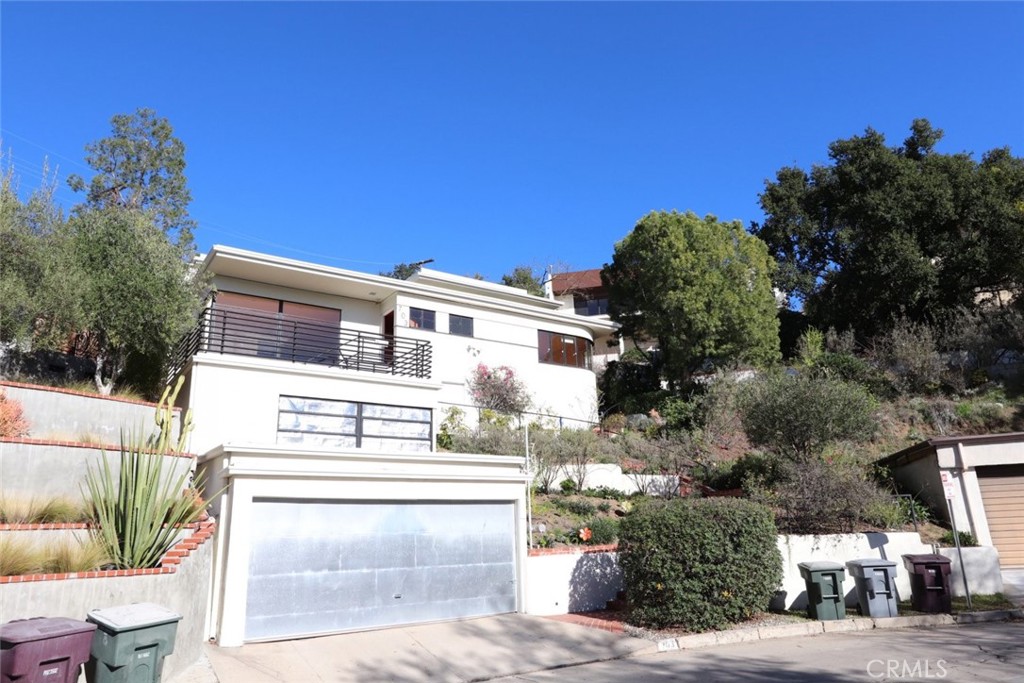 Stunning 1930's Streamline Moderne located in the quiet neighborhood of Woodbury in Glendale with great views of Downtown Los Angeles and beyond! Rebuilt in 2004, this home is move-in ready and features 4-bedrooms, 4-bathrooms, and a spacious 3,031 sqft floorplan. The main floor is open-concept with incredible windows, recessed lighting and glossy flooring. Find the living room, dining area, a bathroom, and a sleek kitchen on this floor. The kitchen includes Kem Weber cabinetry, granite counters, Viking range and a large walk-in pantry. Move on to the 2nd floor featuring bright skylights, a cozy family room, and all bedrooms. Bedrooms are bright and spacious with the primary bedroom complete with a walk-in closet and private bathroom showcasing a jetted tub! On a large quarter-acre lot, this home has a serene multi-level backyard with garden areas, patio spaces, and impressive views from the top of the hill. Located near the Glendale Galleria, Glendale Community College, parks, Downtown Eagle Rock, and easy access to the 2-Fwy and 134-Fwy.