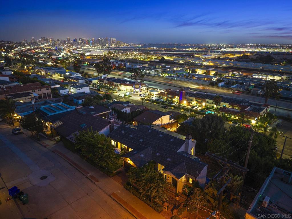 The view is mesmerizing, the presentation is impeccable, and the lifestyle is what dreams are made of! Introducing an executive residence exuding urban refinement in every facet. The drive-up curb appeal is elegant and gracious. Enter the home, and your view through the southwestern walls of glass will leave you breathlessly gazing at the beauty of San Diego’s Harbor, Downtown and Point Loma. The home is a custom rebuild that has assembled exquisite details that you rarely encounter. With high coffered ceilings and warm elegant wood flooring, your emotions will be tantalized at every turn. Featuring over 2,500sf of intelligent living space, this lifestyle has been curated for the fussiest of urban connoisseurs. The floorplan features grand spaces, subtle accents, a kitchen AND prep kitchen made for a TV show, and a primary suite and bath befitting of contemporary royalty. The massive lot beckons for added bedrooms or entertainment space expansion. *See Supplement* This is truly urban sophistication captured. Created approximately 15 years ago, it was meticulously designed to advance all modern sensibilities and yet pay homage to classic historically inspired design. It’s not easy to combine those divergent design viewpoints, but mission accomplished! Modern contemporary demands clean lines and a wide-open concept, anchored in simplicity and function. Classic historic demands symmetry, proportion and order. After spending a very short time here, we are confident that you’ll agree the success is obvious. The stunning kitchen and prep kitchen are pure victory, and indisputably the emotional centerpiece of the home. The timeless contemporary feel is fortified with every creative culinary luxury you can imagine. The massive walnut topped island is a showstopper and integrates multiple cooling drawers as well as precious cabinet organization below. The extensive counters are marble whose color palette is the perfect compliment. The appliance suite features Dacor, Miele, Viking, and GE Monogram, so quality abounds. Not to be ignored is another endless view experience, with a nook bench seat design. Off the kitchen there is a private Zen interior courtyard retreat, boasting a gas fireplace and the ever-important urban garden experience. The lower level also offers the full array of dramatic views and high ceilings. Rest assured there is no let down. The guest room is spacious and elegant with its very own oversized window to the world. The full guest bath is another celebration of elegance. From the delicious tile selection to the luxurious fixtures, there is no disappointment. So many executive homes seem to design primary suites based strictly on size. The primary suite in this home is bathed in elegance, luxury, design and function. There is a grand dual sided wardrobe, an entry hall foyer, and the main bedroom is grand in scale. Step into the primary bath and you’ll feel you could be in one of the most ritzy penthouses anywhere in the city. The standalone tub is an artful masterpiece and ready for hours of relaxation. The bath offers everything from a personal make-up station, huge walk-in shower, western view vistas and an expansive walk-in laundry room. Possibly the most understated feature of this home is the lot size and current orientation of the home. The home is amazing as it currently is, however the location and price point would invite any number of expansions. From an extra bedroom and bath to a pool and spa, the possibilities are extensive, as values on the street have been very strong. Functionally, the home also offers an array of technology and environmental amenities. There is a gray water system for the landscape and yard as well as a fully paid off Solar energy system, complete with battery storage. The home features irrigation, security system with cameras, and a lower level storage room that could be converted to a compact detached office. You wouldn’t know it if you weren’t told, but there is a sound sys...