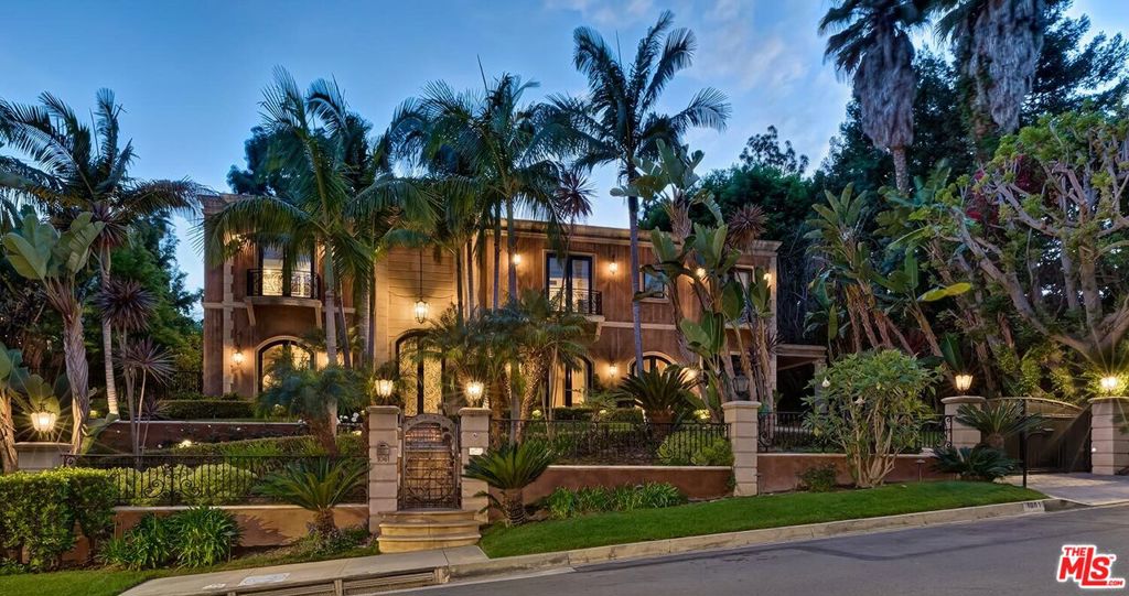 1st time available for lease is this stunning 2sty gated Traditional Mediterranean manse. Custom built in 2005 by its current owners, this home exudes quality in all aspects and is truly a luxuriously elegant gem enhanced by high ceilings, gleaming dark wood and stone floors, venetian plaster elements, beautiful crown mouldings, and French doors. A gated circular drive leads to a grand 2sty skylit entry foyer with massive double steel & glass doors and a sweeping staircase. The perfect central plan affords numerous entertaining possibilities. Large formal living and dining rooms. Living room opens to a wonderful private grassy yard. Separate study/bar room and family room open to the extremely private resort-like grounds with extensive patios, waterfall pool/spa, lawns, firepit, and an outdoor dining area with kitchen and fireplace. Fantastic chef's kitchen with top stainless built-ins and large center isle. Two luxe powder rooms downstairs for heightened entertaining capacity. There is a guest bedroom suite downstairs as well. Four generously sized bedroom suites upstairs including a gracious primary bedroom with fireplace, big balcony, dual walk-ins, and an amazing bathroom. Direct-entry garage for privacy and security. Sited on one of the most prestigious roads in Beverly Hills and moments from the heart of the city and the Westside. Long-term prospects only, please. Can also be available furnished at $60,000/month long-term.