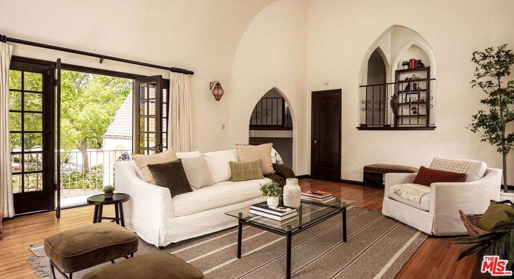 This exceptional 1927 French Normandy home offers 2,642 sq ft of timeless architectural elegance with thoughtful modern updates. Set on over a quarter-acre (11,687 sq/ft), the property showcases exquisite original details Gothic Arches, a spiral staircase with exquisite iron railings, stained glass windows, rich hardwood floors all preserved with care to honor its historic character. The home features 4 bedrooms and 3 bathrooms, a light-filled living room and dining room with graceful proportions, while the updated kitchen blends modern comfort with period charm. Outdoors, the expansive grounds have been crafted by a professional landscape designer and areafully realized vision of natural tranquility. Lush plantings and mature trees create a private sanctuary perfect for entertaining or quiet retreat. The current owners have a complete set of plans for an innovative ADU set at the rear of the the properties massive lot that is in keeping withthe architectural pedigree of the main residence. Located in the coveted neighborhood of Los Feliz, this property offers the rare combination of architectural pedigree, generous outdoor space, possibility for significant expansion and an ideal location near dining, shopping, and Griffith Park.