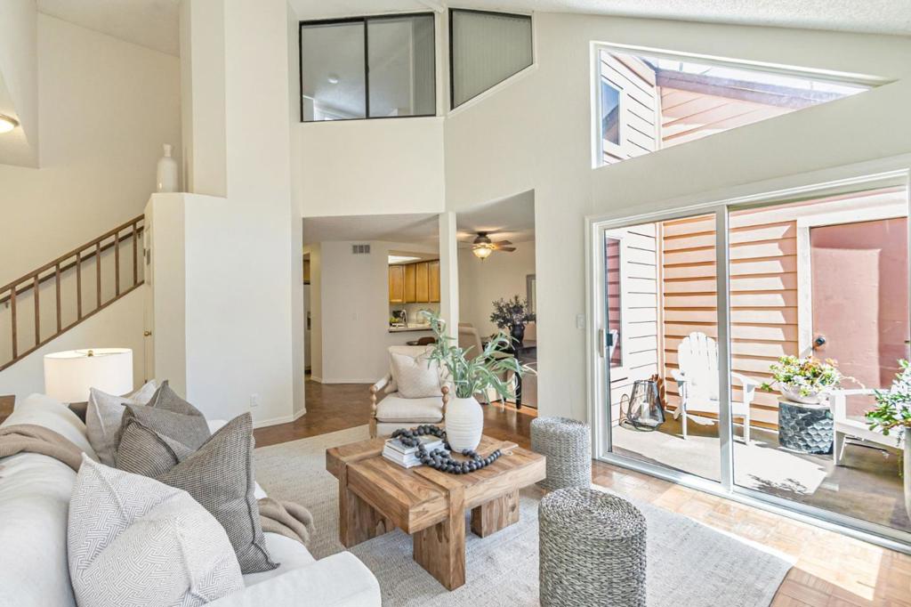Welcome to this bright and spacious 3-bedroom condo in the sought-after Tradewinds community! Designed with flexibility in mind, this home features an open floor plan, vaulted ceilings, and abundant natural light from large windows throughout the unit. Enjoy the comfort of central heating, a cozy fireplace in the living room, warm parquet wood floors, and new carpeting in the bedrooms. The stylish loft bedroom overlooks the living area, while two additional bedrooms, including the primary with a walk-in closet, are located on the main floor. The kitchen is well-equipped with modern amenities and has updated stainless steel appliances. A convenient in-unit washer and dryer are included. Rare perks for condo living: a private 1-car garage, an additional assigned parking space, and extra storage on the balcony. The community boasts beautiful green lawns, a sparkling pool, and a separate hot tub. Don't miss your chance to own this cheerful, well-appointed homestop by this weekend and fall in love!