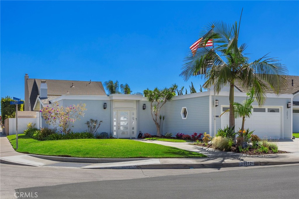Fall in love with this meticulously maintained 4-bedroom, 2-bathroom gem nestled on a quaint cul-de-sac in the “Moffett tract” South of Adams in the heart of Huntington Beach, just over two miles from the sandy shores. Spanning 1,660 square feet, this light-filled home effortlessly blends modern upgrades with timeless mid-century modern character, perfect for relaxed beachside living. Step beyond the threshold of the front door into a charming and private front patio area where you can entertain effortlessly with indoor-outdoor living, thanks to a sliding door that opens to the spacious living room with stunning vaulted ceilings. Enjoy the ambiance of the rock wall with a firepit—perfect for cozy evenings with family and friends. A hidden treasure awaits near the entry—a vintage whiskey bar tucked behind a closet door, adding a touch of retro flair. The open-concept layout of the home flows seamlessly from the living room to the formal dining room, which opens onto the charming remodeled kitchen with a seated breakfast bar - ideal for gatherings. Bathed in natural light from a stunning skylight, the kitchen features stainless steel appliances, stone countertops, and a cozy seated breakfast area with a view out of the bay window to the beautifully landscaped backyard. The primary suite is a serene space with an attached sitting room, generous closet space, and an attached bathroom with a skylight. One bedroom doubles as a functional home office with two built-in workspaces, perfect for remote work or creative pursuits. Skylights throughout the home enhance its bright and airy ambiance. The home boasts modern upgrades, including new landscaping, new exterior and interior paint and a new roof in 2025, double-pane vinyl windows, a wood bay window, and French doors, a smart-controlled QuietCool fan system, as well as an attached two-car garage. This Huntington Beach haven combines style, comfort, and proximity to the beach, making it the perfect place to call home.