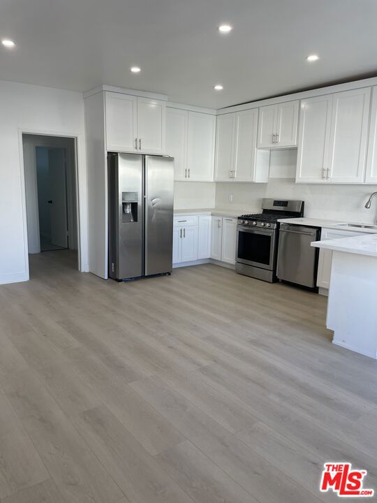 Discover modern living in Sherman Oaks with this luxurious 3-bedroom, 2-bath remodeled apartment! Nestled in a prime location right across from the esteemed Kester Elementary, this is the perfect place to call home. The apartment has been completely redone with new wood lam. floors throughout, new LED recessed lights, high ceilings, new dual glazed windows, new custom kitchen cabinets with calacatta countertops, stainless steel appliances (dishwasher, range/oven, microwave, fridge), 3 very large and spacious bedrooms, newly redone bathrooms, a private outdoor balcony, new AC/Heat system, and plenty of natural light. The building has been recently updated with a painted exterior, access controlled entry and cameras all around, secured parking, onsite manager, laundry onsite and a swimming pool.
