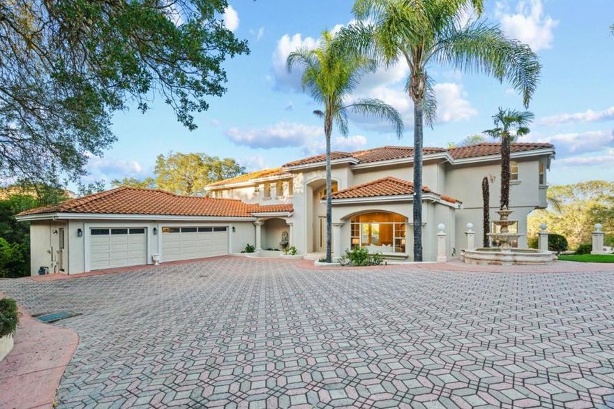 Experience luxury living in this newly remodeled 5 bed/ 3 bath estate where timeless Mediterranean architecture meets modern sophistication. Set behind a private gate on a beautifully landscaped acre, this home offers sweeping city views, elegant interiors, and resort-style outdoor amenities. A grand foyer with stained-glass ceiling and crystal chandelier opens to formal living and family rooms, each with gas fireplace.The brand-new chefs kitchen features shaker cabinetry, quartz counters, a 6-burner Viking range, built-in Viking fridge and microwave, large island with bar sink, and walk-in pantry. Formal dining area with gorgeous chandelier and unobstructed views. Ground-floor bedroom and stylish full bath are perfect for guests. The expansive primary suite offers a balcony, fireplace, massive walk-in closet with island, and spa-style bath with dual quartz vanities, soaking tub, shower, and Toto smart toilet. 3 additional bedrooms plus an office/bonus room share an updated bath. Private-entry lower room is ideal for gym or studio. Resort-style grounds include an infinity pool with spa, 6-hole putting green, outdoor kitchen with fireplace and BBQ, rotunda with fountains, and multiple entertaining patios.3 Car Garage. Close to trails, wineries, and vibrant Downtown Morgan Hill.