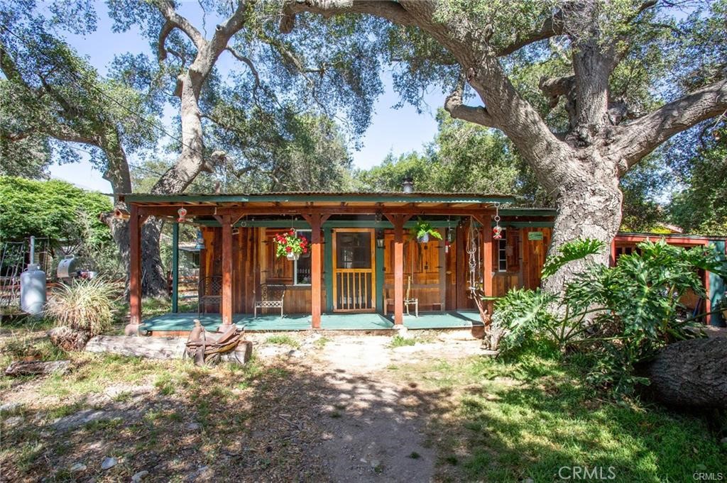 Peaceful Country Living – Minutes from Everything!
Rare opportunity to own a unique property with a seasonal creek (pan for gold), flat usable land, and endless potential. Situated on an expansive 8,232 sq ft lot with peach tree, this charming home offers the best of both worlds, a tranquil rural ambiance with convenient access to city amenities.
The main residence is accompanied by a finished outbuilding (approx. 181 sq ft of additional space), ideal for a home office, creative studio, or guest overflow. The attached one-car garage adds functionality and storage. Zoning allows for up to three horses, making this an ideal spot for equestrian enthusiasts or those looking to create a mini ranch-style retreat.
The lot is dotted with mature oak trees that offer natural shade and beauty, while the seasonal creek adds a serene, storybook setting. Whether you choose to renovate, expand, or rebuild, the lot size, layout, and location open up a world of possibilities.
Located on a paved road with generous street frontage, county utilities (water, gas, electricity) are already connected. Trash collection is also available. Enjoy the laid-back lifestyle of this historic canyon community—just a short walk to the Trabuco Oaks Steakhouse and the Trabuco General Store.
Bring your tools, your imagination, and your love of nature—this property is ready to become something truly special.