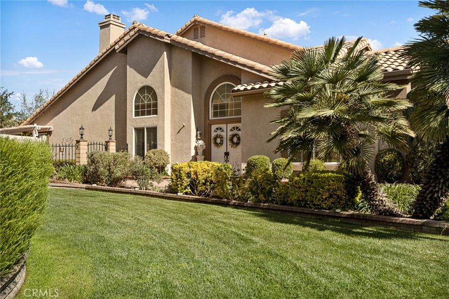 Welcome to your own private paradise located in the spectacular Sun Lakes gated 55+ active adult community!  No Mello-Roos! This exquisite home boasts a serene, beautifully landscaped backyard featuring custom-designed, luscious, manicured landscapes highlighted by a large rock boulder and tiered waterfall fountain. Accented by beautiful greenery and flowering perennials, the tranquil and relaxing sound of water spilling from the waterfall enhances your outdoor living experience. Enjoy an English sculpted garden, covered patio, and built-in BBQ—perfect for entertaining or relaxing. The thoughtfully elevated gardens provide privacy, ideal for adding your personal spa retreat right outside the primary suite. Enter through a lovely, private, level entrance to find elegant designer tile and plush carpeting complemented by chic, modern touches. The expansive formal living and dining area greets you with soaring two-story ceilings, ample natural light, and a sophisticated dual-sided fireplace. Updated designer gold and crystal chandeliers enhance the elegant ambiance of the dining room. The recently refreshed kitchen features freshly painted cabinetry, stylish backsplash, and coordinating countertops, seamlessly connecting to the casual dining nook and second living area. High ceilings, plantation shutters, and large windows throughout offer abundant light and additional views of the stunning fireplace. Retreat to the main-level primary suite with vaulted ceilings, direct backyard access, a generous walk-in closet, dual sinks, luxurious soaking tub, and expansive walk-in shower. Upstairs, discover a spacious loft area, two additional bedrooms, and a full bathroom—ideal for guests or versatile living space. Sun Lakes offers unparalleled amenities, including championship and executive golf courses, pro shops, tennis, pickleball, bocce courts, two restaurants, a remodeled bar/lounge, and three clubhouses featuring indoor and outdoor pools, spas, fully-equipped gyms, ballroom, billiards, library, craft rooms, and over 80 clubs and activities. Conveniently located less than an hour from mountains, deserts, and beaches, and mere minutes from Desert Hills Premium Outlets and Morongo Casino. Don’t miss this rare opportunity—make this secluded gem your forever dream home today.    For a walk through video check out this link. http://www.1521fairwayoaksave.com/mls/193320496.