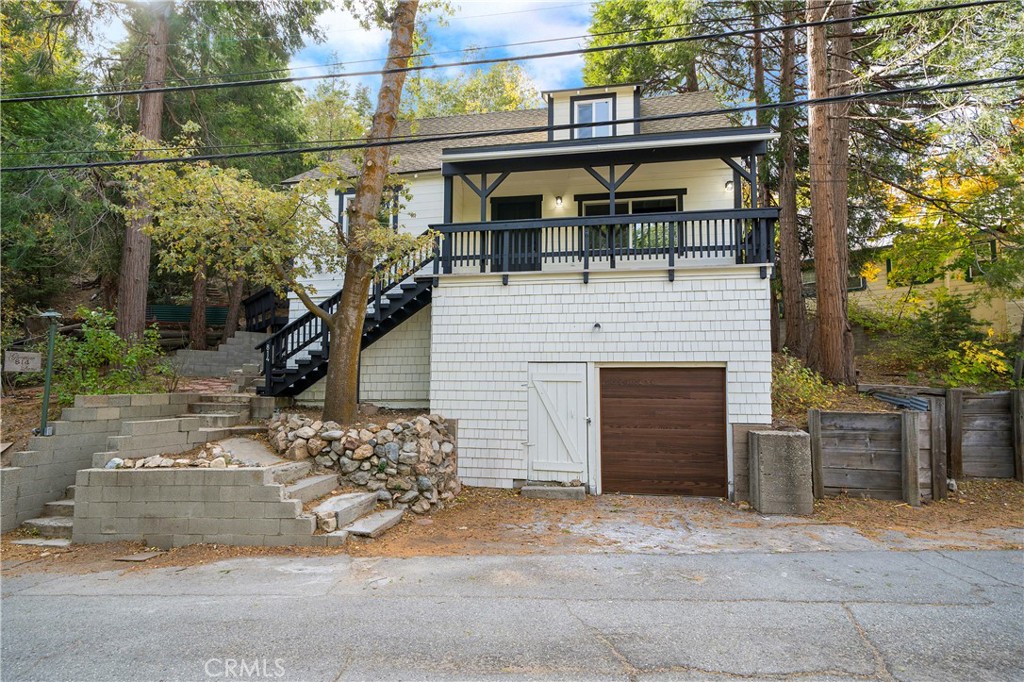 Nestled in the peaceful community of Twin Peaks, this inviting 3-bedroom, 2-bathroom cabin is the ideal retreat for anyone seeking a blend of rustic charm and modern convenience. With 126 feet of frontage, the cabin is very unique in its offering of ample parking, an attached garage, and an elongated driveway to the left of the home. Thanks to its almost 13,000 square ft fenced lot you also have a tremendous amount of privacy and usable land also rarely found on hillside cabins!
Inside, you'll find an open and airy floor plan with beautiful shaker cabinets, sleek quartz countertops, and stainless steel appliance package, lending a touch of elegance to the kitchen. The large master suite is a true sanctuary, offering generous space and comfort, perfect for unwinding after a day of mountain adventures with secondary exterior access to a lovely deck nestled amongst the trees. Upstairs are two additional guest bedrooms and a guest bathroom providing spacious accommodations for both kids and guests alike. This Twin Peaks cabin has it all—space, style, and a serene setting—making it the perfect mountain getaway or forever home. Don't miss your chance to own this charming property!