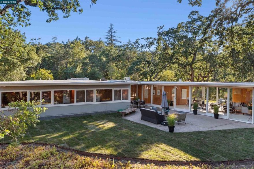 Nestled on a largely level lot with sweeping views of Mt. Diablo and the surrounding hills, this classic, single-level mid-century home offers exceptional privacy, a graceful floor plan, and seamless indoor-outdoor living.  Floor-to-ceiling windows fill the living and dining rooms with natural light throughout the day, while expansive glass doors open to lush, verdant grounds for a true indoor-outdoor connection. The spacious eat-in kitchen provides generous counter space and abundant storage. Warm wood accents in the living areas, bedrooms, and hallways create a welcoming, timeless ambiance.  The primary suite includes a private dressing area, and each of the three bedrooms enjoys serene views of the gardens and hillsides. Set in a coveted Lafayette neighborhood of distinguished homes, this property is just blocks from downtown and minutes to top-rated K–12 schools, the Lafayette Reservoir, BART, and the acclaimed shopping and dining of Lamorinda, Walnut Creek, and beyond.