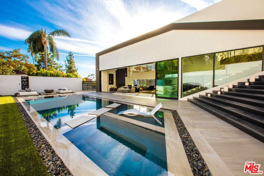 Price varies based on furnished/ unfurnished option. Privately situated in the highly sought after neighborhood of BHPO, this villa makes for the perfect getaway. A must-see contemporary gem models sleek architecture, accompanied by clean lines and walls of glass that boasts luxury. Fully equipped amenities and an open floor-plan give the property the ultimate entertainers vibe; with elegant indoor outdoor flow from the kitchen to the living room, to the backyard. Multiple wet bars, glowing porcelain tiles, and 16 ft ceilings give the spacious home a unique feel. Circular driveway allows for easy ingress and egress, as well as a covered tow car garage. Layout includes a spacious master suite with a private patio & fire pit, plus three other en-suite bedrooms all separated from the main entertainment floor. Backyard includes barbecue area, fire pit, and heated pool. All perfect for entertaining or enjoying a cozy night in.