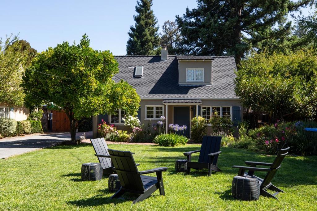 Conveniently located in the heart of Allied Arts, this enchanting home blends vintage charm with modern updates on a rare, deep lot of approx. 1/4 acre. A Dutch door opens to warm interiors with chevron-patterned floors, loads of natural light, and French doors. The spacious living room features a fireplace and access to the yard, the formal dining room offers custom cabinetry, yard and kitchen access. The kitchen opens seamlessly to the family room with sliding doors to the rear yard and access to stairs leading to the finished basement. Main-level bedroom or office, powder room and laundry room. Upstairs features 3 bedrooms, one with a French door to a sweet balcony, and 2 updated baths with vaulted skylights, clawfoot tub, built-ins, and balcony access, the other with a curved glass shower. The finished basement of an additional approx. 290 sq ft, adds bonus space perfect for home office or recreation room. The magical yard includes multiple entertaining spaces with patios, fire pit, BBQ gas line, deck, play area, fruit trees, and a detached 2-car garage with loft (plumbed for potential ADU). Fantastic location-Close to Stanford, Caltrain, parks, and downtown Menlo Park/Palo Alto. Excellent schools, rare large lot - incredible opportunity awaits.
