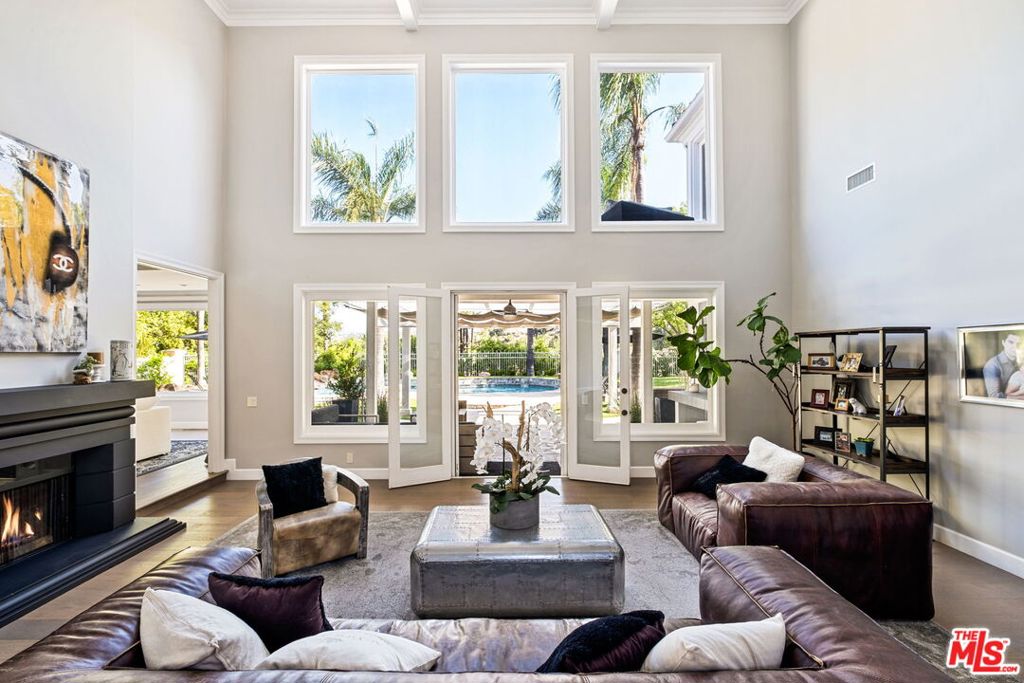 Located in the prestigious guard-gated community of Mountain View Estates in Calabasas, this pristine furnished estate boasts breathtaking pastoral and sunset views. Sunlight pours through expansive bay windows, illuminating the bright, naturally lit interiors. This home has been fully updated, featuring a designer kitchen with a large center island and top-of-the-line Viking stainless steel appliances. With an inviting open floor plan, engineered wood flooring, high ceilings, and custom window treatments throughout, this residence exudes elegance.The home offers five generously sized bedrooms with ample closet space, including a luxurious master suite with dual his-and-hers closets and an expansive master bath. Additionally, there's a state-of-the-art home movie theater for your entertainment needs.The expansive backyard is an entertainer's dream, complete with a pool and spa, a built-in BBQ area, multiple entertainment zones, and a spacious patio. Situated on a quiet street, this stunning home offers a prime location, a desirable open floor plan, a sizable, usable lot, and magnificent views in one of the most esteemed Las Virgenes School District. The home is available furnished.