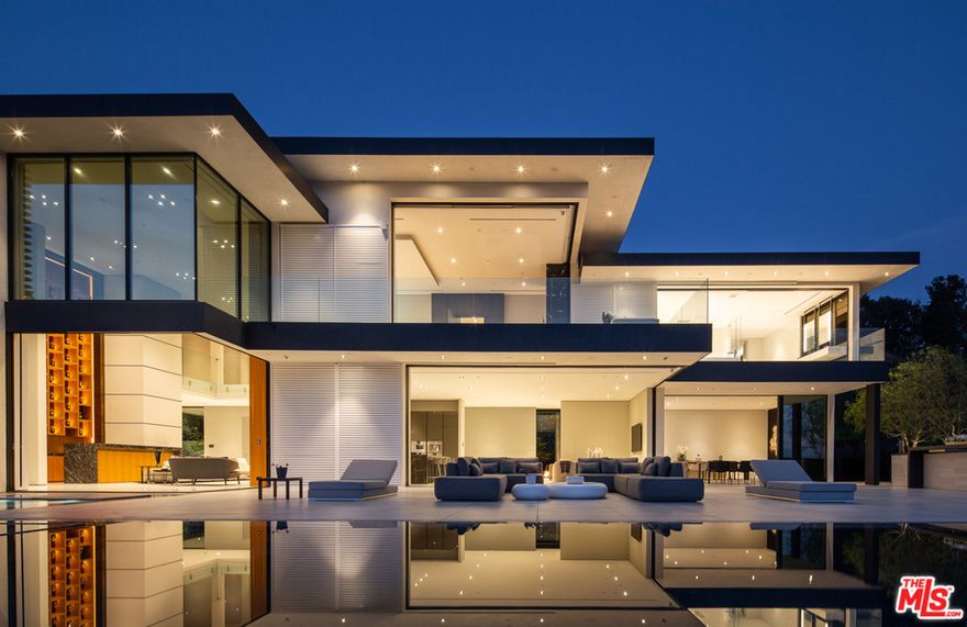 Distinguished architectural residence built in the exclusive Doheny Estates neighborhood in the Bird Streets. Private and gated, sited on an almost 1 acre promontory with panoramic city to ocean views. The entrance features a 10-car motor court with an impressive frontage leading to the grand foyer. Double height ceilings and floor to ceiling windows invite natural light and maximize views whilst seamlessly connecting indoor and outdoor space. Main level features sophisticated living spaces including the family, dining, and library with breathtaking city views. Lower level houses a home theatre, living room, wellness, and entertainment areas with an underground connection to the guest house. Upper level includes family bedrooms and gorgeous master suite with walls of glass.  An artful lifestyle experience perfect for entertaining.  Neighboring property is available, perfect for staff, extra guests or future expansion potential, combined total land size of 52,091 sf / 1.2 acres.