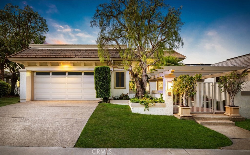 Perched in the exclusive gate-guarded enclave of Harbor Ridge, this stunning 3-bedroom, 3-bathroom residence with an additional office showcases sweeping panoramic views that stretch across the city lights, dramatic skylines, and, on clear days, the snow-capped mountains. A rare opportunity to experience refined Newport Beach living, this home blends timeless sophistication with modern comforts. Step through the private gated entry into a lush courtyard accented with brick inlay, ambient lighting, and vibrant landscaping—a serene prelude to the elegance within. The custom stained-glass double doors open to a sun-filled interior enhanced by skylights, recessed lighting, and expansive windows that capture breathtaking vistas at every turn. The main living spaces are designed for both relaxation and entertaining. The living room boasts soaring ceilings and opens seamlessly to a private patio, while the family room is anchored by a granite-framed fireplace and sliding glass doors that extend the space outdoors. The chef’s kitchen features black onyx granite countertops, an island with a warming drawer, and top-tier appliances including Sub-Zero refrigeration, Thermador ovens, Bosch dishwasher, and a four-burner Thermador gas cooktop—ideal for both everyday meals and hosting with ease. Upstairs, the office provides built-in workspaces and exceptional light. The primary suite is a private retreat with two walk-in closets, including an expansive cedar-lined dressing room, and a spa-inspired bath with dual sinks, a soaking tub, and a separate shower. French doors lead to a balcony where sweeping horizon views create the perfect backdrop for morning coffee or evening relaxation. Additional highlights include a freshly painted interior, wood flooring, dual-pane windows, a programmable climate control system, and thoughtfully upgraded finishes throughout. Residents of Harbor Ridge enjoy access to resort-style amenities including four pools and spas, three tennis courts, and picturesque walking trails. Ideally located just minutes from world-class shopping and dining at Fashion Island, the award-winning Pelican Hill Resort and Golf Course, pristine beaches, and top-rated schools, 31 Saint Tropez embodies the very best of the coastal California lifestyle.
