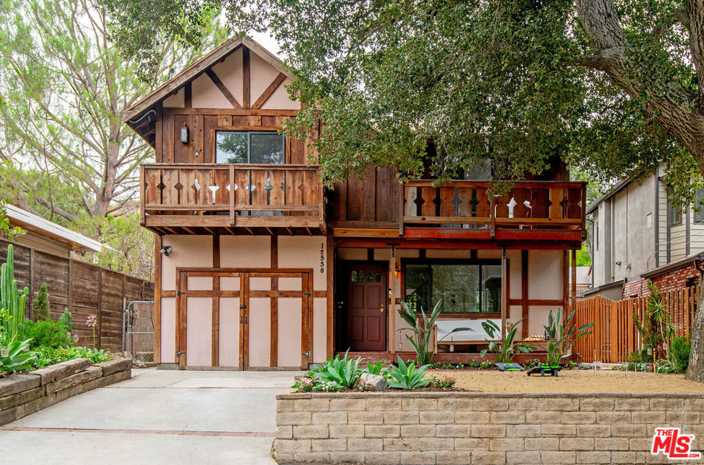 Welcome to your private sanctuary in the hills of Kagel Canyon, where rustic charm meets modern comfort just minutes from the city. Nestled against the Angeles National Forest and just steps to Dexter Park, this hidden gem puts you in the heart of a vibrant canyon community known for its equestrian trails, local events, and the beloved Hideaway Bar. Peacocks, horses, and chickens roam nearby, while birdsong and quiet sounds of nature fill the air. Inside, the home features a living room with lush views and a stone fireplace, a dining area with sliding glass door access to the backyard, three bedrooms, two bathrooms, an office/den, and versatile guest quarters with a king-size Murphy bed. A beautifully renovated primary bath adds a touch of luxury, while updates like a new dishwasher, two refrigerators, and laundry machines enhance everyday convenience.Outdoor living shines in this foothill retreat. The private backyard features a terraced garden with barbecue and dining area, while balconies off the upstairs bedrooms capture unforgettable sunsets. The newly renovated guest quarters offer outdoor access, a mini-split system, and flexibility for family, visitors, or creative pursuits. A generous front yard, landscaped grounds, and the numerous nearby parks make space for play and gatherings. Life here means a rare blend of serenity and connection, where nature, neighbors, and convenience meet. With enviable proximity to Burbank, the airport, freeway connections, Metrolink, golf, fishing, and more. Don't miss your chance to own a slice of tranquility in one of Sylmar's most nature-rich neighborhoods!