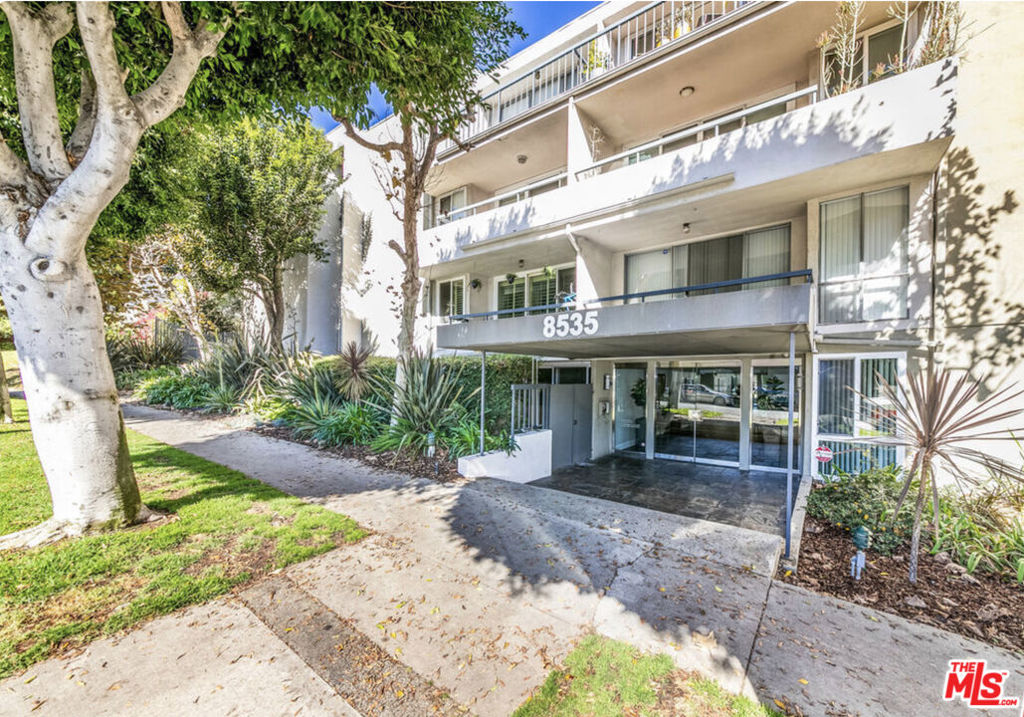 Tucked away on a charming tree-lined street in the highly desirable "Norma Triangle", this beautiful 1 bed 1 bath West Hollywood condo is a unique corner end-unit on the 2nd floor, with City views from the dining room. Towering mature trees provide privacy for both the balcony and the bedroom. Set back from the street, the location is quiet and serene. The condo features Central AC & Heat, a decorative fireplace, and private balcony. The kitchen has been remodeled with stone counters, glass tile backsplash with stainless steel accents, and all stainless steel appliances, including a deep refrigerator, full-size dishwasher, a glass-surface electric range, and a built-in microwave. The bathroom features a large custom-tiled walk-in shower with a "rain" shower-head, and a double vanity. The hallway includes a large closet for storage, while the generously sized bedroom includes a walk-in closet with built-ins. * Located within an easy walk of Santa Monica Blvd, as well as gyms, grocery stores, restaurants and the Melrose shopping district. The building features secure entry, gated subterranean parking, a sparkling heated pool and a dry sauna. Each floor has its own laundry room. The elevator to the parking garage is just around the corner, and the exterior stairwell (also gated) is just down the hall, for easy access whether bringing in groceries or just going for a walk. Unit has one parking space in garage. Guest-parking is located just off the side-entrance to the building. The HOA is SB-326 Compliant, and the HOA's Insurance includes Earthquake coverage.