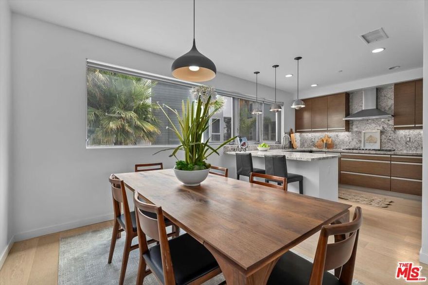 A rare opportunity to own one of the most coveted residences in Marina del Rey's sought-after Latitude 33 Beach Collection. This beautiful canal-facing corner townhome offers exceptional privacy, timeless design, and water views that are simply unmatched. End-units of this caliber rarely come to market especially one with elevated finishes, direct access, and a location just moments from the sand. With 4 bedrooms and 3 full baths, this sunlit end-unit lives like a single-family home. The thoughtful floor plan maximizes natural light with expanded windows, serene water vistas, and no shared neighbor on one side. On the first level, a flexible bedroom suite lives like a separate studio-style space ideal for guests, multigenerational living, or a private office. Be sure to view the floorplans in the photos. Every space is designed for comfort and style from the custom walnut built-ins and sleek gas fireplace to the open-concept living and dining area ideal for entertaining. The chef's kitchen features top-of-the-line Thermador appliances, breakfast bar seating, wine fridge and ample storage. Step outside to a canal-facing patio perfect for enjoying morning coffee or golden-hour sunsets, with walking trails just steps away. Retreat to the tranquil primary suite, complete with a spa-caliber bath offering a steam shower, jetted soaking tub, dual vanities, and Toto fixtures. Oak hardwood floors, curated lighting, designer closets, and in-unit laundry elevate the everyday. Additional highlights include: Direct-entry 2-car garage with EV charging, Guest parking, Concierge service & on-site gym, Secure, well-maintained community. Perfectly positioned closest to Venice, you'll enjoy instant access to the best of beachside living, Abbot Kinney, coastal bike paths, world-class dining, and vibrant Westside culture. This is SoCal coastal living at its finest rare, refined, and ready to enjoy.
