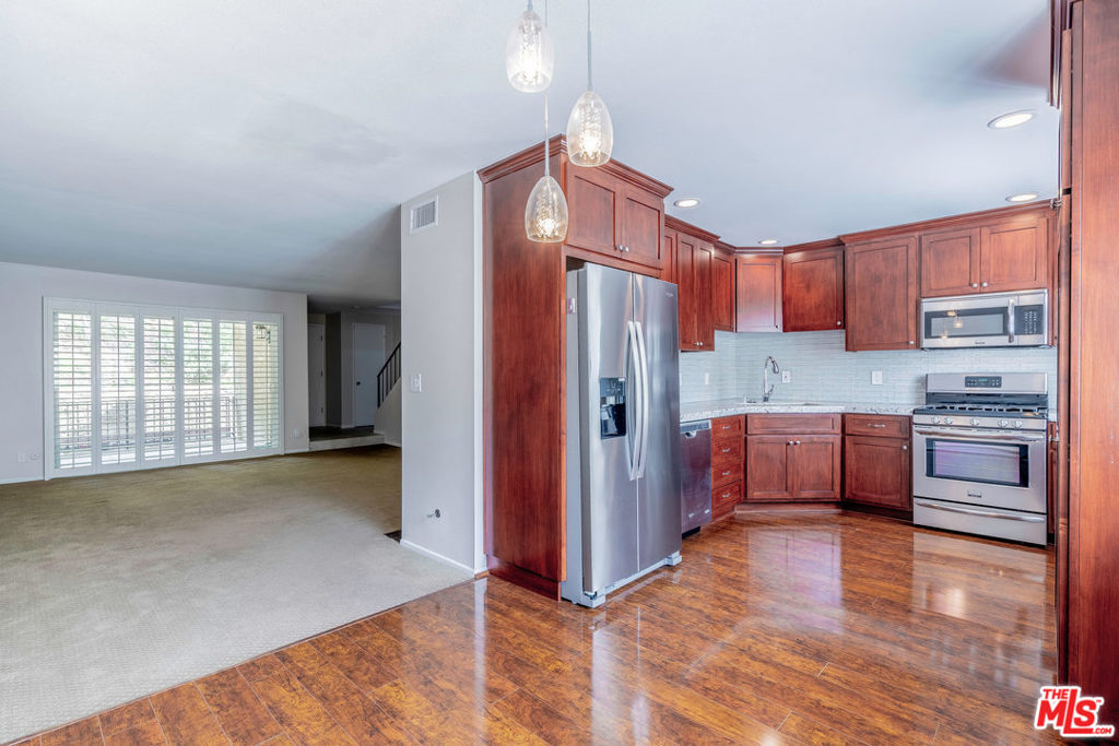 Beautifully updated 2 + 2.5 townhome in Cabrini Villas, which boasts 7 pools, clubhouse, basketball, tennis courts, 4 acre park + private security. Open floorplan features spacious kitchen w/newly upgraded granite countertops, custom cabinets/hardware, stainless steel appliances + beautiful wood floors. Large dining area opens to the oversized living room w/newly rebuilt fireplace + expansive patio. Recently installed high-end carpeting in living room + bedrooms. Refrigerator, washer/dryer included. Master suite w/park views, spacious walk in closet + gorgeous en suite bathroom with upgraded vanity, huge walk in glass shower and luxurious tub. 2nd bedroom has bathroom w/upgraded vanity + shower, large walk-in closet + plenty of light. Downstairs bonus room great for office, gym or crafting. Plantation shutters, recessed lighting + many upgrades! Two car garage w/built in storage. HOA pays earthquake, fire insurance, basic cable, water, grounds maintenance. City and mountain views!
