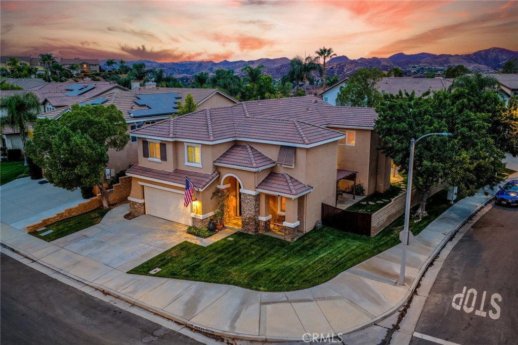 At the top of Castaic's popular "Hillcrest Park" site this move-in condition 5 bedroom PLUS loft pool home! One of the best values in the area and it sits on a wide corner lot at the front of the cul-de-sac. From the moment you pull up its clear the home has been meticulously maintained, and the decor is neutral throughout. Tile and wood floors, shutters and sharp interior paint. There is a full bedroom and bath downstairs and 4 more rooms upstairs with a very open feel to the layout. The upstairs primary bath was recently remodeled and has a huge walk-in shower, which is especially impressive. Large walk-in closet too with built-ins. The spacious kitchen has a walk-in pantry, granite counters, tasteful backsplash, stainless appliances and the refrigerator is included. Outdoors is perfect for entertaining with a full length covered patio, pool/spa and large side yard with extra patio/conversation area. Great location, price and no HOA fees. Hurry on this one!