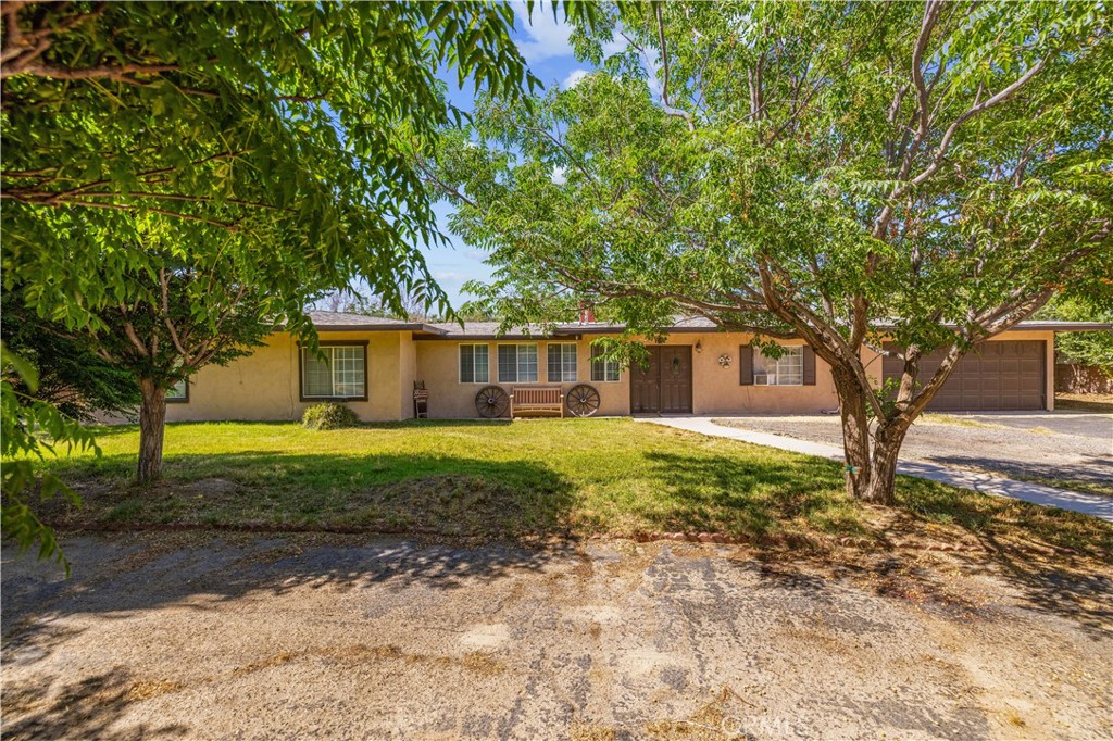 A Wonderful Opportunity in the Heart of Littlerock. 2 homes on 1 lot. Where Rustic Charm Meets Endless Possibilities! Welcome to your own private oasis! This extraordinary estate offers over 3,000 sq ft of living space, featuring 6 bedrooms (with 2 master bedrooms), 4 bathrooms, and nearly a full acre of land, perfectly combining comfort, charm, and opportunity. Step through the stucco privacy walls into a timeless hacienda-style retreat that immediately transports you. The thoughtfully designed floorplan boasts expansive living areas, ideal for entertaining and multi-generational living. From the cozy living room to the elegant formal dining space and oversized family room, every corner flows seamlessly into the large, inviting kitchen. A hand crafted fireplace anchors the space with warmth and authentic character. Outside, the magic continues. Enjoy multiple patio areas, hammocks under shady trees, and a dedicated outdoor dining space designed for relaxation and entertaining under the stars. The lush grounds are adorned with a variety of fruit and shade trees, bringing nature's bounty right to your doorstep. Perfect for hobbyists, entrepreneurs, or animal lovers, this property features a massive 4 car garage/shop area that has updated electrical lights and outlets and also water access. Storage sheds, animal enclosures. Additional highlights include: Public water and natural gas for convenience. The detached guest house offers its own private living space with 1 bedroom, 1 bathroom, a living room, dining area, and full kitchen, ideal for extended family, guests, or potential rental income. Peaceful, private setting with room to breathe and grow. This isn't just a home it's a lifestyle. Don't miss your chance to own a one-of-a-kind property that truly has it all.