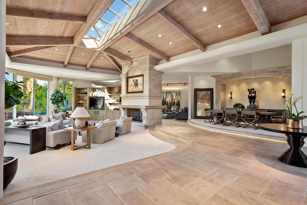 This gorgeous Guy Dreier designed home has expansive views and absolute privacy. With over 9,854 square feet on the main level and 4,000 square feet on the bottom level, including the garage, this spacious property is the perfect mountainside retreat. The primary suite has a gorgeous stone fireplace and a large bathroom with two closets. The great room provides breathtaking views, a center-peak skylight, a sit-down bar and access to formal dining. The kitchen has plenty of counter space and a service kitchen for food prep. Two en suite guest rooms and adjoining seating area with its own kitchenette are located opposite the main suite. Down the massive spiral staircase you'll find the most charming 50's style diner with all the bells and whistles showcasing its authenticity. The movie theater complete with a ticket booth and concession stand provide the ultimate experience. The hidden wine cellar has space for small dinner party. The large air-conditioned garage has room for 10+ cars and other toys.