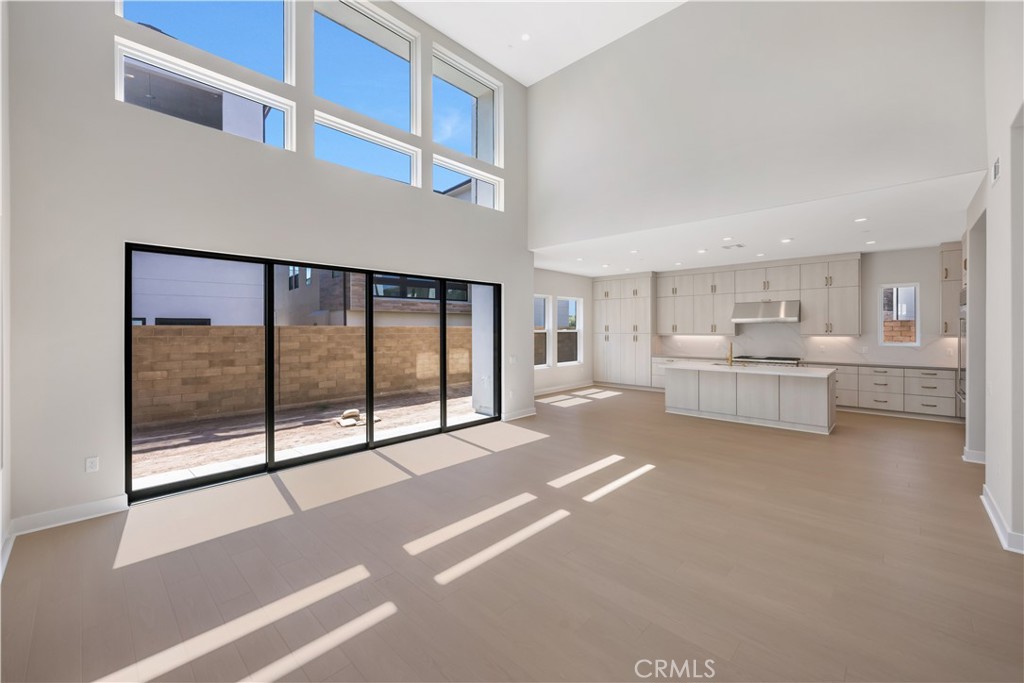 Brand-new luxury home with solar panels, 6 bedrooms, 5 bathrooms, and a loft with a covered deck—nestled in Irvine’s sought-after Great Park community. Enjoy soaring ceilings, abundant natural light, and a chef’s kitchen with high-end appliances and walk-in pantry. The first-floor suite is perfect for guests or multigenerational living, while the expansive primary offers a spa-inspired bath and huge walk-in closet. Each bedroom has its own bath, and the third-floor loft opens to a private deck for relaxing or entertaining. Energy-efficient features, including solar, help cut electricity costs without sacrificing comfort. Walking distance from top-rated Cadence Park School (K 8) and Portola High School, and minutes from resort-style parks and pools, and Irvine’s best shopping and dining.