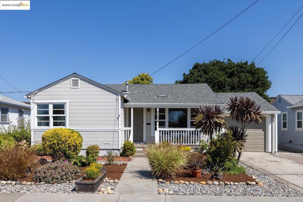 This thoughtfully designed residence offers both comfort and ease of living on a 5,170 sq ft lot. A sunny entry porch sets the tone for the home, leading into a single-level floor plan with minimal steps for seamless access, and features 2 bedrooms and 1 full bathroom. Inside, the 876 sq ft layout includes an inviting eat-in kitchen with a dining nook, ideal for everyday meals or casual gatherings. The attached garage with interior access adds convenience and functionality. Outdoors, the property opens to an expansive, flat rear yard, fully fenced for privacy and versatility. Grassy areas, a covered patio, and a lounge space create multiple options for relaxation, play, or entertaining. The low-maintenance front garden adds curb appeal while ensuring ease of care. A rare combination of thoughtful interior flow and generous outdoor living, this home offers a balanced blend of practicality and possibility. Close to BART, transit, shops and Castro Valley shopping!