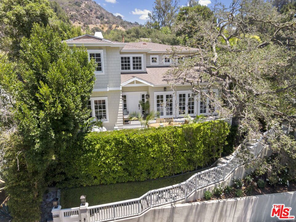 This beautiful gated ultra secluded home was custom designed and quality constructed from the ground up and completed in 2009.Elevated entry deck with spectacular canyon views to a formal entry with 18 ft ceilings and sweeping staircase. Sun-filled open flow spaces with multiple French doors to the front and back yards for the seamless indoor-outdoor ambiance that embraces the California lifestyle.Great flair, attention to detail, and designer accents throughout. Gourmet kitchen with large center island and custom-built cabinetry with top-of-the-line appliances. The main floor also boasts a family room, dining room, great room, office & gym.The 2nd-floor luxe main suite entering through double doors has a high vaulted ceiling and a beautiful custom-built fireplace, exquisite large main bathroom with a walk-in closet. 3 additional bedrooms and 2 additional bathrooms are also on the 2nd floor. This home also offers a unique guest house with custom-built bunk beds, a bathroom, and a kitchenette. Perfect for out-of-town guests or extended family and friends.An exceptional home that encapsulates that relaxed informal lifestyle that is perfect for entertaining or just making memories with family.