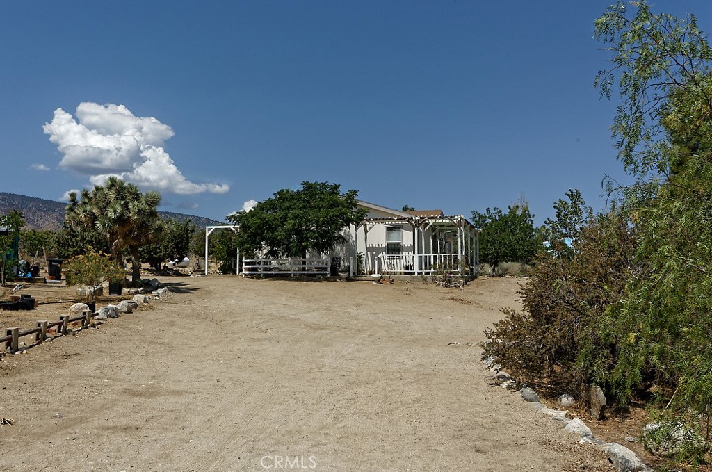Welcome to 1895 Barkley Ranch Rd., Pinon Hills, CA – Your High Desert Oasis in the Making!
This 3-bedroom, 2-bath manufactured home offers 1,437 sqft of living space on 2+ fully fenced acres, blending peace, privacy, and potential in one of the most scenic areas of the High Desert. Set just off a paved road, this property is ideal for those who value accessibility and open space.
The home features a large covered patio and a built-in outdoor BBQ, perfect for entertaining or soaking in the sunsets and sunrises you can only dream about. Enjoy full views of the majestic Wrightwood Mountains, creating a stunning backdrop for everyday living.
This property includes a greenhouse, two storage sheds, mature shade trees, and animal enclosures, offering everything you need to create a self-sustaining homestead, hobby farm, or desert retreat. With a little work and your personal touch, this home has all the beginnings of a true High Desert Oasis. Experience the beauty, space, and freedom of High Desert living. Don't miss this great opportunity to own a slice of peaceful desert living with all the essentials already in place!