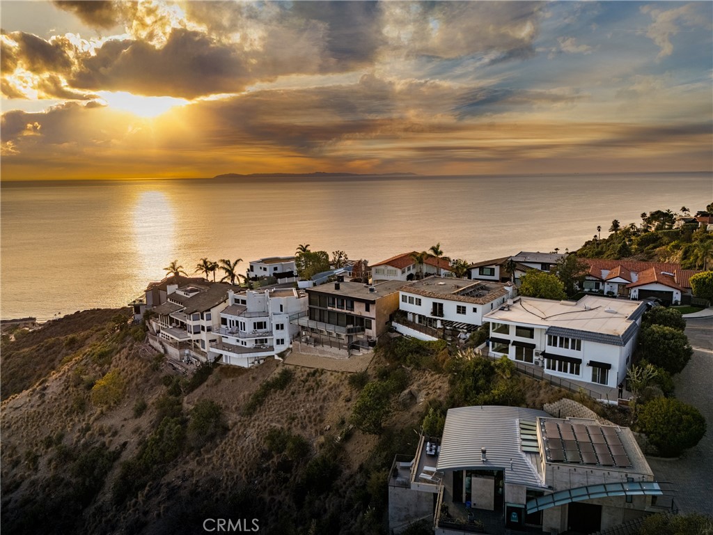 Spectacular panoramic, unobstructed white water and coastline views are simply inspiring from this dramatic completely renovated contemporary home with open floor plan, towering 20 foot ceilings and walls of glass. Terrazzo stone and newer floors, quartz countertops and massive stone fireplace. A gourmet kitchen with stainless appliances, breakfast nook, formal dining and Great room with soaring two story ceiling frames the amazing views of the Pacific. A curved staircase leads to 3 spacious bedrooms including primary with large walk-in closet and jaw-dropping views. A large den on the main floor can be converted to be a fourth bedroom. Private, gated courtyard with sparkling pool and view terrace with built-in BBQ creates the ultimate outdoor living. Easy access to world class beaches, restaurants, and shopping.