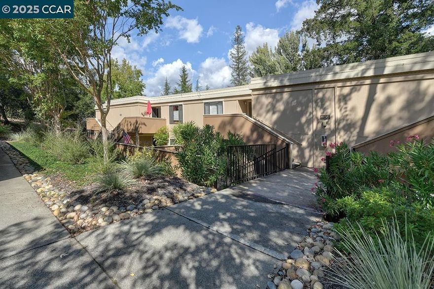 Charming and beautifully updated, this 2-bedroom, 1.5-bath Carmel home offers storybook appeal in a prime location. Features include gorgeous hardwood floors, a stylish kitchen with granite countertops, stainless steel appliances, and custom cabinetry. The serene primary bedroom overlooks lush greenery and includes a spa-like bathroom with a stone shower and granite vanity. A modern half bath enhances the guest space. Enjoy outdoor living on the slate-tiled front patio or the expanded rear patio with garden. Extras include crown molding with accent lighting, plantation shutters, in-unit washer/dryer, finished exterior storage, and nearby carport space. A true Carmel gem!