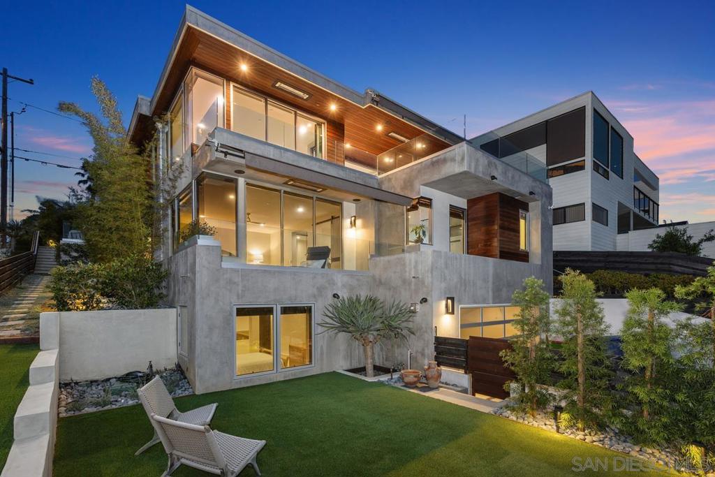 This newly built luxury custom contemporary home in Cardiff-by-the-Sea is a masterpiece of modern design, offering panoramic whitewater ocean views. The home seamlessly integrates indoor and outdoor living with private decks featuring La Cantina bi-fold doors, a BBQ kitchen, overhead heaters, and built-in sound systems. Newly landscaped yard with Pet Turf. Designed as a full smart home, it includes a gourmet chef's kitchen with Miele appliances, an in-home custom theater and multi-floor elevator. The grand primary suite boasts ocean views, luxury finishes, an oversized bathroom and walk-in closet, a coffee bar kitchenette, all offering a tranquil retreat for comfort and relaxation. The lush exterior space expands the living area and enhances the coastal experience, offering a perfect blend of natural beauty and modern luxury.