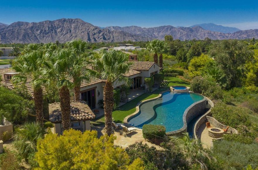 Fabulous contemporary Mediterranean estate perfectly situated at the end of a cul-de-sac and perched atop the World Class; Tom Fazio designed golf course at the coveted Madison Club. Extraordinary quality and open floor plan design all punctuated with motorized sliding glass walls opening to the sparkling infinity edge pool, spa, inviting gazebo, yard and firepit.  Spacious covered patio with golf course and mountain views perfect to enjoy sunsets, watch a game or retreat from the sun.  Large, open chef's kitchen with island seating, adjacent to spacious family room and dining room with views to the patio. The luxurious master wing features imported marbles and limestones, the master spa bath showcases an antique copper soaking tub with warm and inviting wood floors throughout. Reminiscent of the finest resorts and spas for a vacation at home.  There are 3 additional suites including a fully self-contained guest casita with kitchenette. Stunning use of tiles and stones for a luxury guest or long-term stay.  Timeless family retreat with the utmost quality for the most discerning buyer.