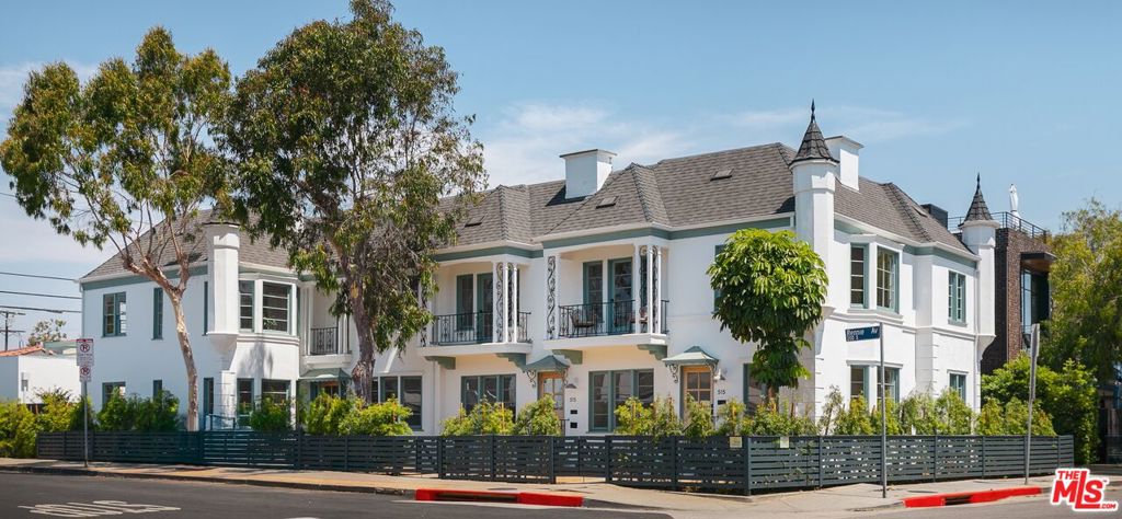 Welcome to Chateau des Roses, a designated Los Angeles Historic-Cultural Monument and designed by prolific architect Max C. Drebin. Celebrated for its corbeled turrets, mansard roof, decorative detailing, and cultural significance, this Venice landmark offers a once-in-a-lifetime opportunity at the corner of Rose & Rennie. This upper 2-bedroom, 2-bath corner unit is flooded with natural light. The spacious living room flows seamlessly into a full dining area, while original hardwood floors add timeless character throughout. The bright kitchen blends historic charm with modern convenience, featuring stainless steel appliances and open shelving. Two generously sized bedrooms, two bathrooms, and updated systems including new HVAC, new roof, and modernized plumbing and electrical ensure comfort and peace of mind. In unit washer and dryer, ample closet space, a private garage, and an oversized rooftop deck designed for entertaining complete the offering. This space is perfect for hosting friends and enjoying Venice sunsets. Situated in the heart of this cultural hub, Flake, Wabi Sushi, Vin on Rose, Day Glow, and Cinque Terre are just outside your door, with the beach only moments away. Combining historic charm, modern livability, and unparalleled outdoor entertaining, this is an opportunity not to be missed.
